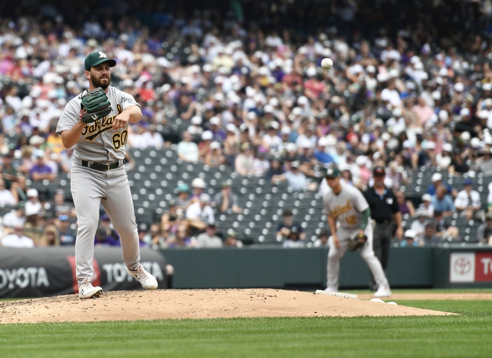 A's pitcher Sam Moll throws to first against the Rockies on Sunday, July 30, 2023. (CarsonFieldcarson.field@gazette.comhttps://secure.gravatar.com/avatar/c524ef3d384945349bed78d70eb2d2cd?d=mm&r=g)