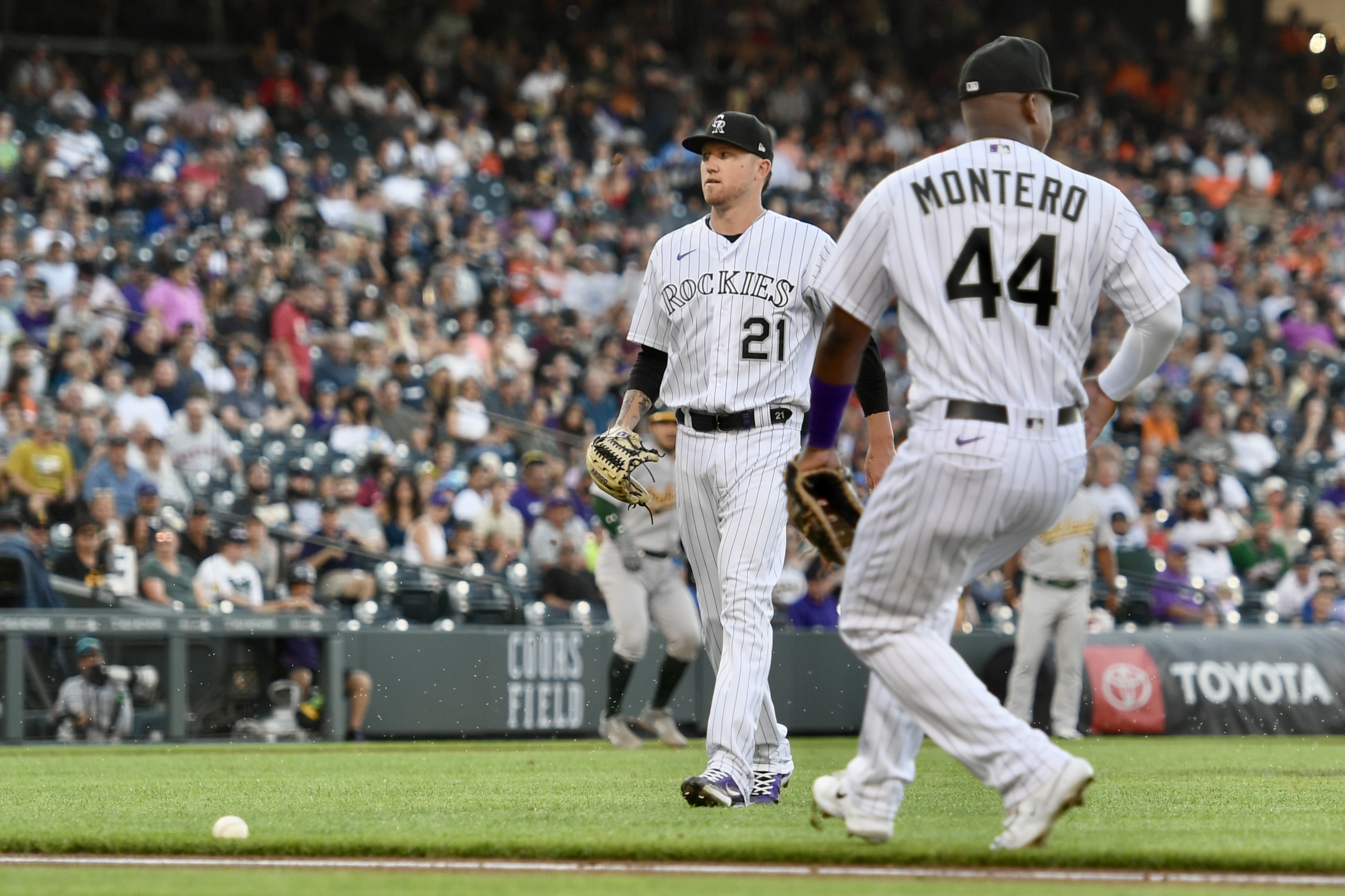 Kyle Freeland and Elehuris Montero walk to a ball that just stayed fair for an infield single against the Oakland Athletics on Friday, July 28, 2023. (CarsonFieldcarson.field@gazette.comhttps://secure.gravatar.com/avatar/c524ef3d384945349bed78d70eb2d2cd?d=mm&r=g)