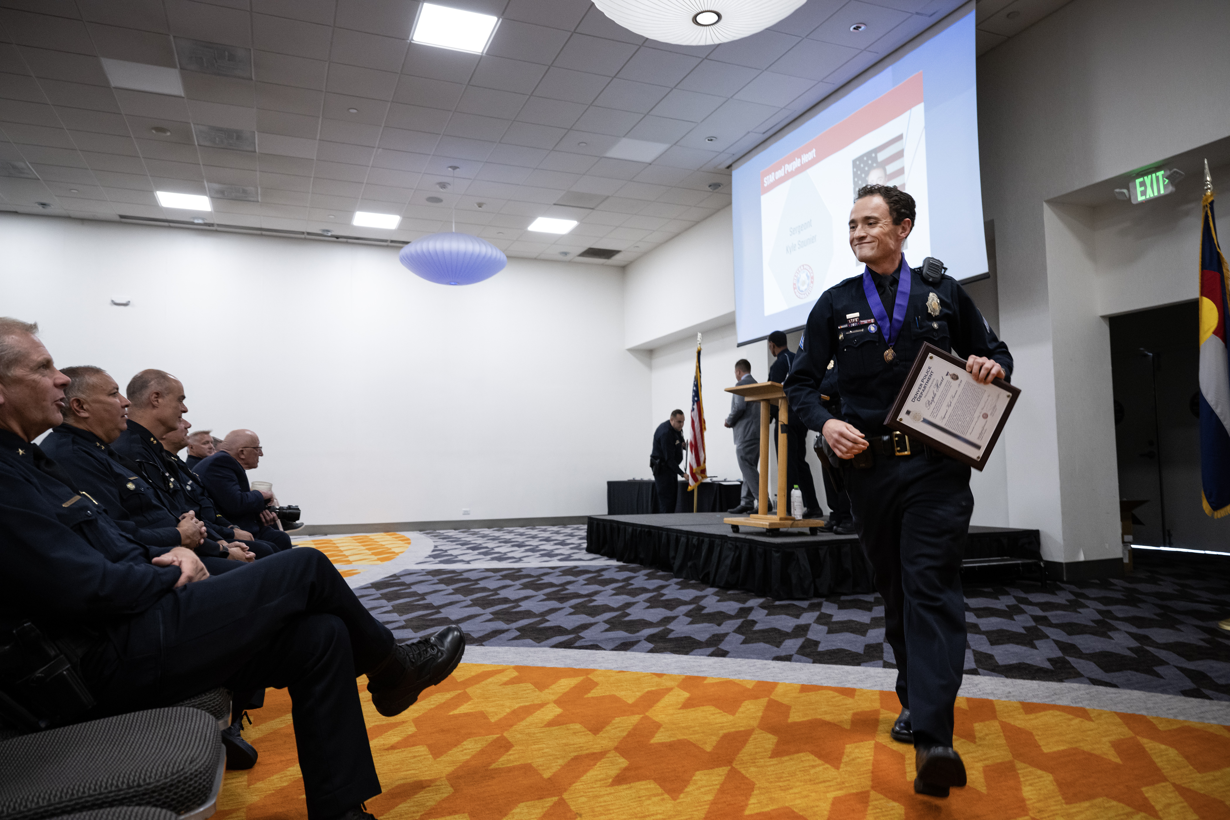 Denver Police Department Sgt. Kyle Saunier walks back to his seat after receiving both the STAR and Purple Heart awards during the Denver Police Foundation Award Ceremony on Monday, July 24, 2023, at The Curtis Hotel in Denver, Colo. (Timothy Hurst/Denver Gazette) (TimHursttim.hurst@gazette.comhttps://secure.gravatar.com/avatar/aca82bd62b4ee425c598527cd6faa1b1?d=mm&r=g)