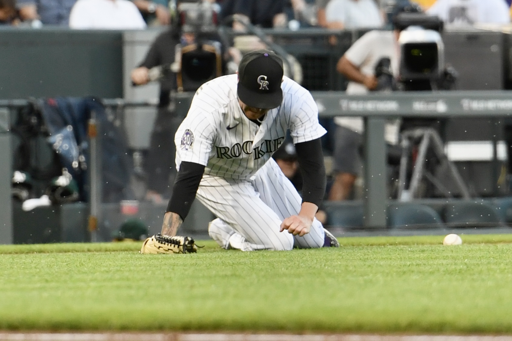 Rockies pitcher Kyle Freeland falls trying to field a ball against the Oakland Athletics on Friday, July 28, 2023. (CarsonFieldcarson.field@gazette.comhttps://secure.gravatar.com/avatar/c524ef3d384945349bed78d70eb2d2cd?d=mm&r=g)