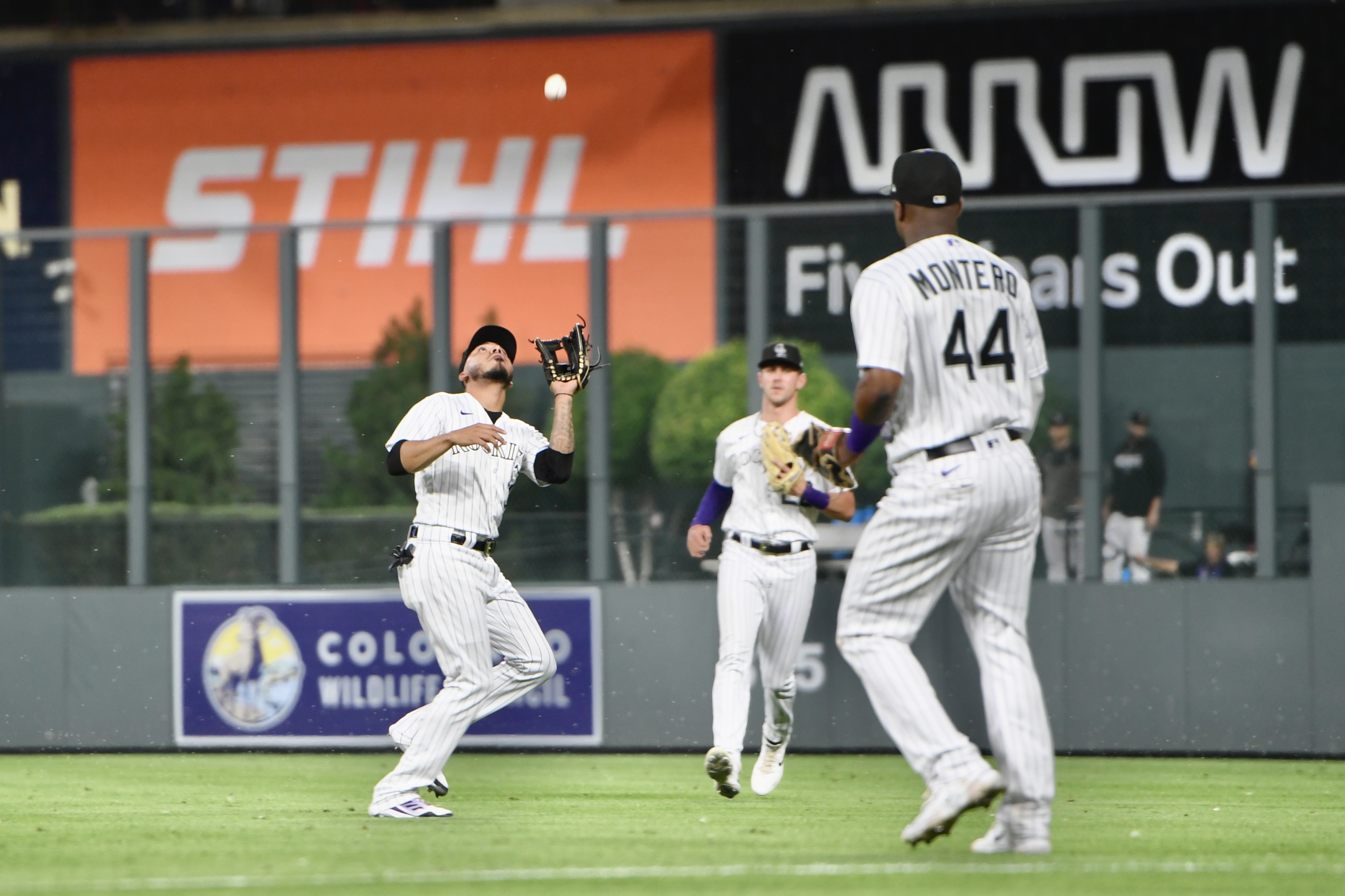 Rockies infielder Harold Castro prepares to catch a ball as Nolan Jones and Elehuris Montero watch against the Oakland Athletics on Friday, July 28, 2023. (CarsonFieldcarson.field@gazette.comhttps://secure.gravatar.com/avatar/c524ef3d384945349bed78d70eb2d2cd?d=mm&r=g)