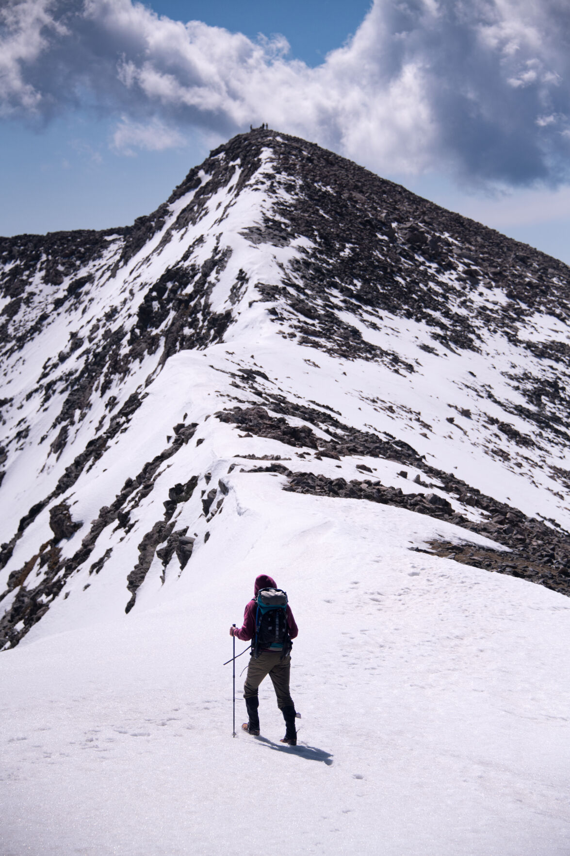 Dan Crossey crosses a snowfield as he nears the summit on his climb of Culebra Peak last month. Culebra Peak, the southernmost fourteener in the state, is on private land and has had restricted access since 1999. (Mark Reis)