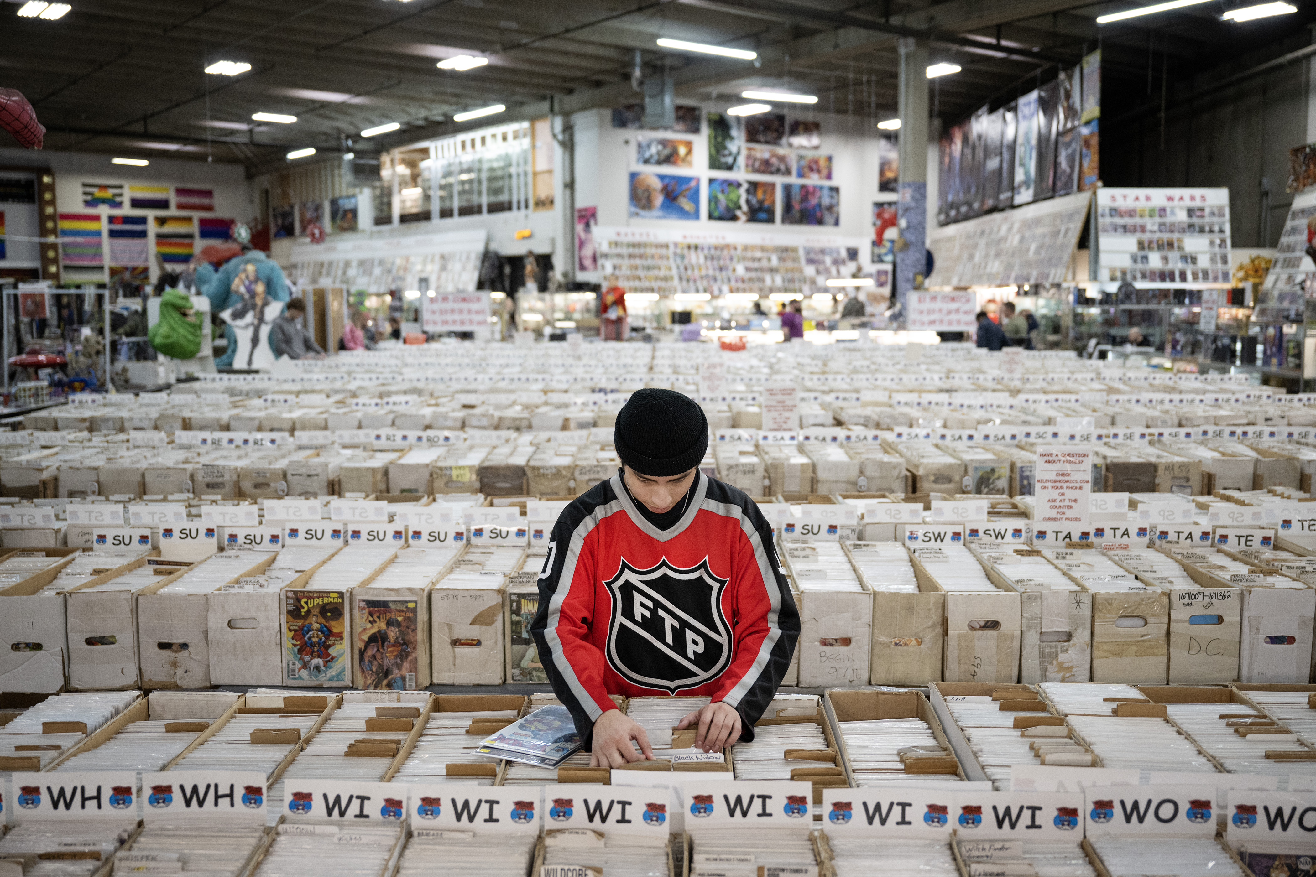 George Villalobos thumbs through boxes of comics for copies of Venom comics on Saturday, Feb. 11, 2023, at the Mile High Comics Jason Street Mega Store in Denver, Colo. (Timothy Hurst/Denver Gazette) (TimHursttim.hurst@gazette.comhttps://secure.gravatar.com/avatar/aca82bd62b4ee425c598527cd6faa1b1?d=mm&r=g)