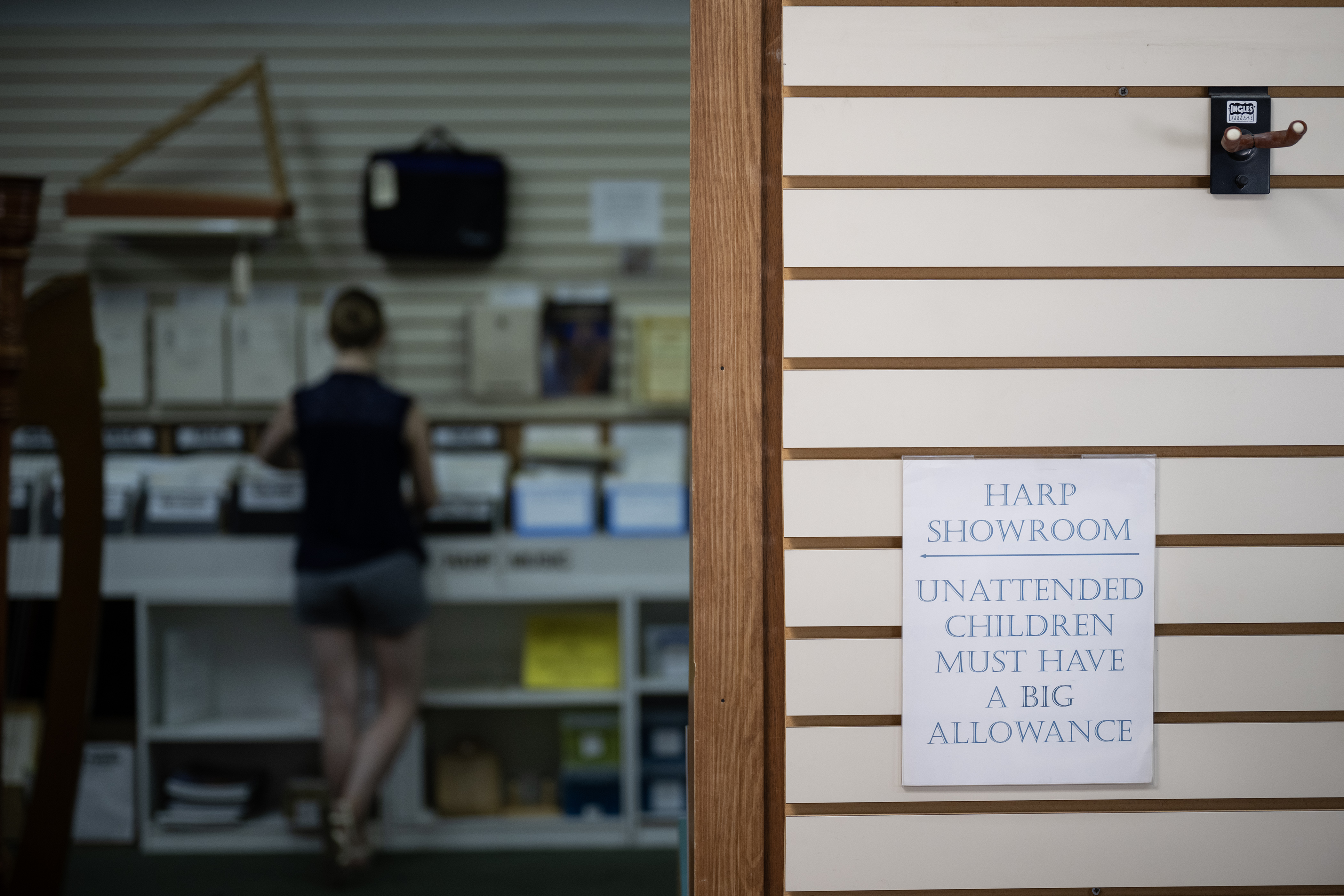 A sign eluding to the cost of the instruments in the harp showroom as Alisa DeWitt, President of The Mile High Chapter of the American Harp Society, sifts through racks of sheet music on Monday, July 17, 2023, at Kolacny Music Co. in Denver, Colo. Word has gotten around the harpist community that Kolacny Music is closing, and in an effort to help them clear out inventory DeWitt and her mother Debbie Hickox came in to buy sheet music. (Timothy Hurst/Denver Gazette) (TimHursttim.hurst@gazette.comhttps://secure.gravatar.com/avatar/aca82bd62b4ee425c598527cd6faa1b1?d=mm&r=g)