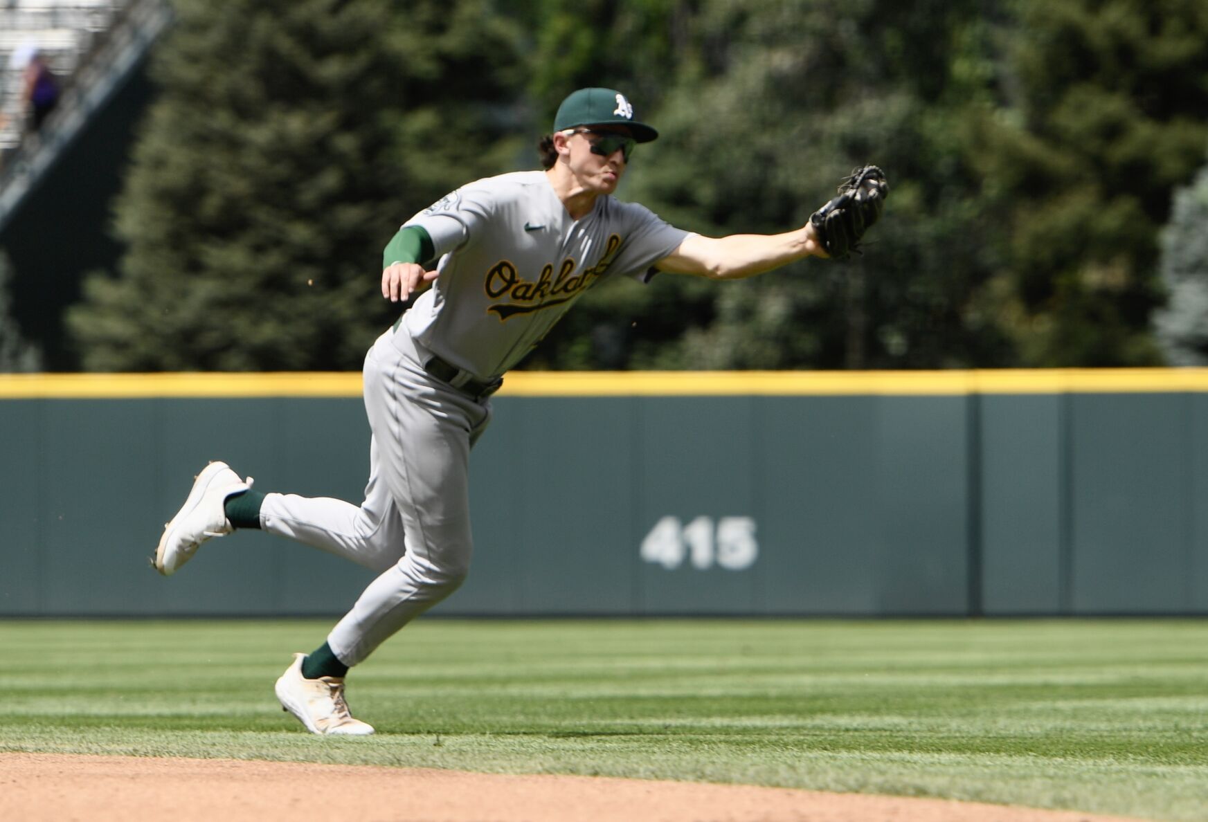 A's infielder Zack Gelof snags a ball off a bounce against the Rockies on Sunday, July 30, 2023. (CarsonFieldcarson.field@gazette.comhttps://secure.gravatar.com/avatar/c524ef3d384945349bed78d70eb2d2cd?d=mm&r=g)