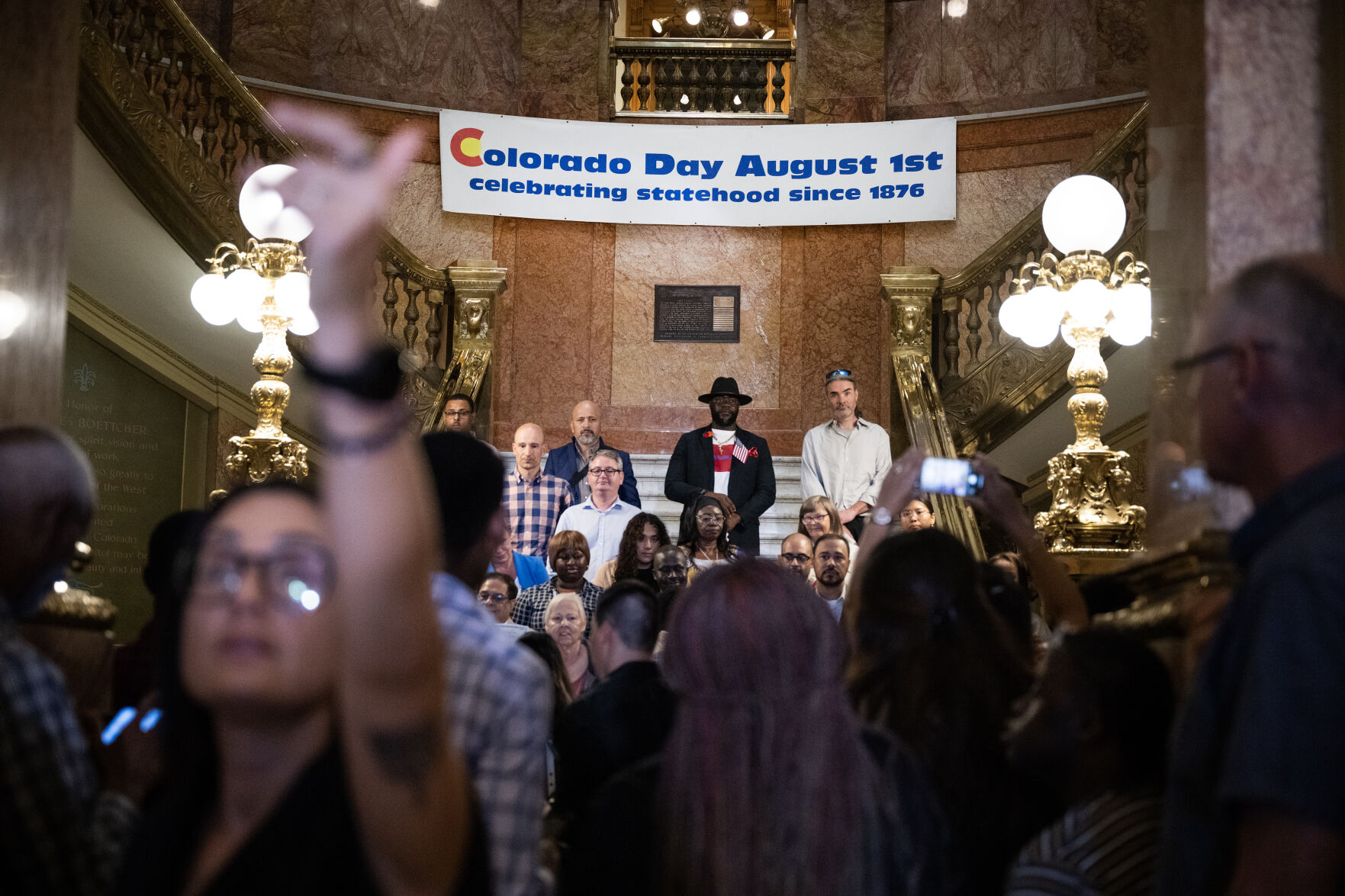 35 new U.S. citizens get setup on the rotunda staircase for a photo after a naturalization ceremony at the Colorado State Capitol building on Tuesday, Aug. 1, 2023, in Denver, Colo. The 35 new U.S. citizens from 20 different countries took the Oath of Allegiance from United States Citizenship and Immigration Services Kansas City district director David Douglas, held at the Capitol in celebration of the 147th anniversary of President Ulysses S. Grant signing a proclamation that officially declared Colorado a state. (Timothy Hurst/Denver Gazette) (TimHursttim.hurst@gazette.comhttps://secure.gravatar.com/avatar/aca82bd62b4ee425c598527cd6faa1b1?d=mm&r=g)
