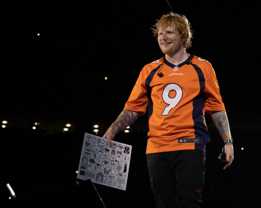 Ed Sheeran emerged for his encore on Aug. 19, 2023, with a Denver Broncos jersey and a menu from Casa Bonita. (Mark Surridge)