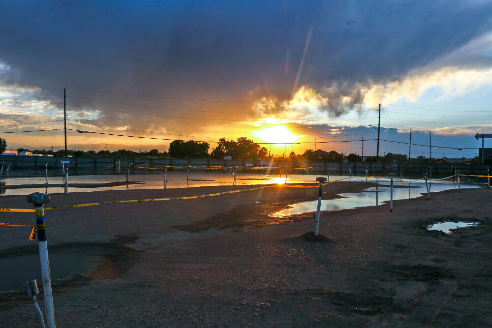 The sunset cast a lovely blanket over The 88 Drive-in, which for some unspecified reason is half-covered in standing water. Aug. 8, 2023. (John Moore, Denver Gazette)