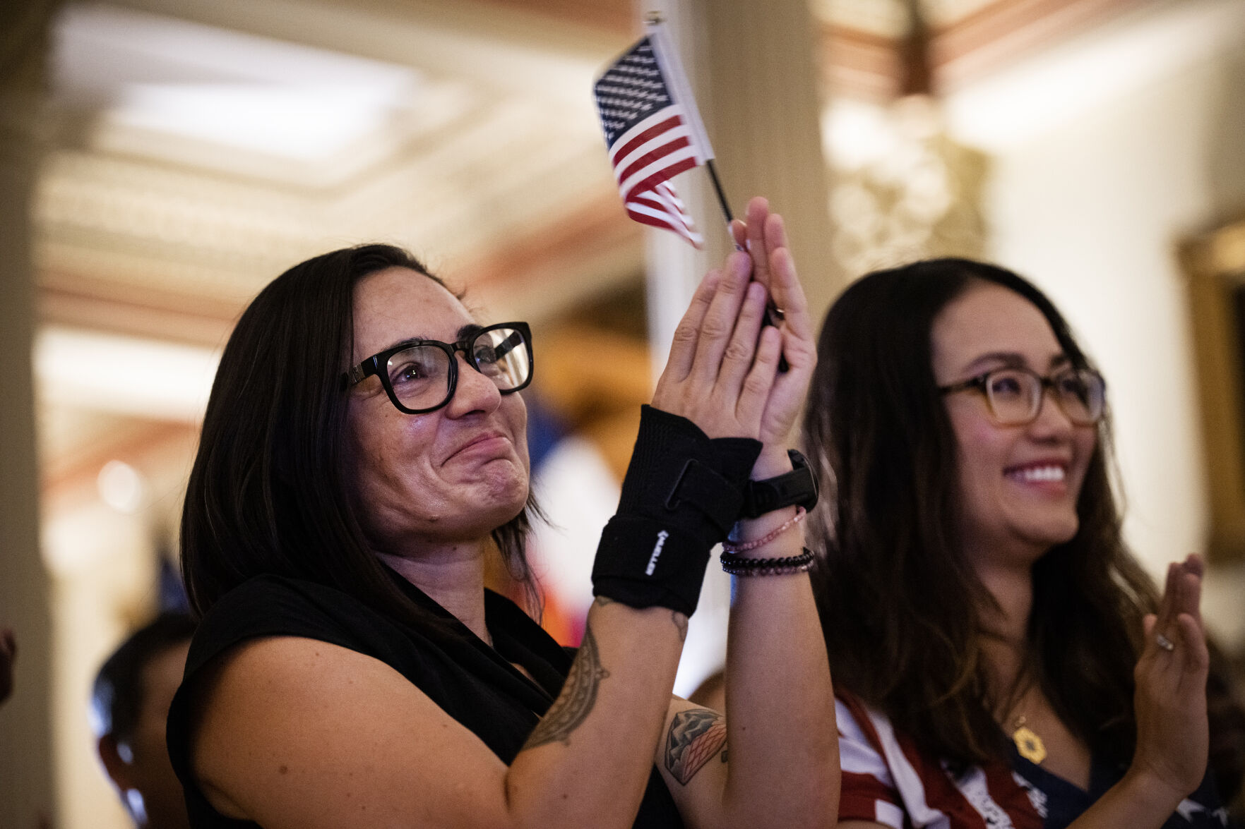 Daniela Campbell, a digital coordinator for the Office of the Governor, applauds after taking the Oath of Allegiance with 34 other new U.S. Citizens during a naturalization ceremony at the Colorado State Capitol building on Tuesday, Aug. 1, 2023, in Denver, Colo. The 35 new U.S. citizens, from 20 different countries, took the oath from United States Citizenship and Immigration Services Kansas City district director David Douglas, held at the Capitol in celebration of the 147th anniversary of President Ulysses S. Grant signing a proclamation that officially declared Colorado a state. (Timothy Hurst/Denver Gazette) (TimHursttim.hurst@gazette.comhttps://secure.gravatar.com/avatar/aca82bd62b4ee425c598527cd6faa1b1?d=mm&r=g)