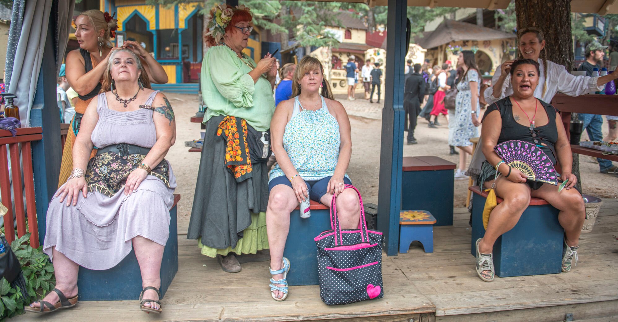 Multiple hair-braiding booths scattered the grounds of the Colorado Renaissance Festival in Colorado Springs, Co., on Saturday, July 29, 2023. (Gabi Broekema)