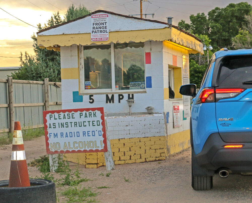 The drive-up box office at The 88 Drive-in, ironically, has a 'closed' sign in its window (though it is not – yet), and a sign saying admission is $8 – though the price was raised to $10 long ago. Photo taken Aug. 8, 2023. (John Moore, Denver Gazette)