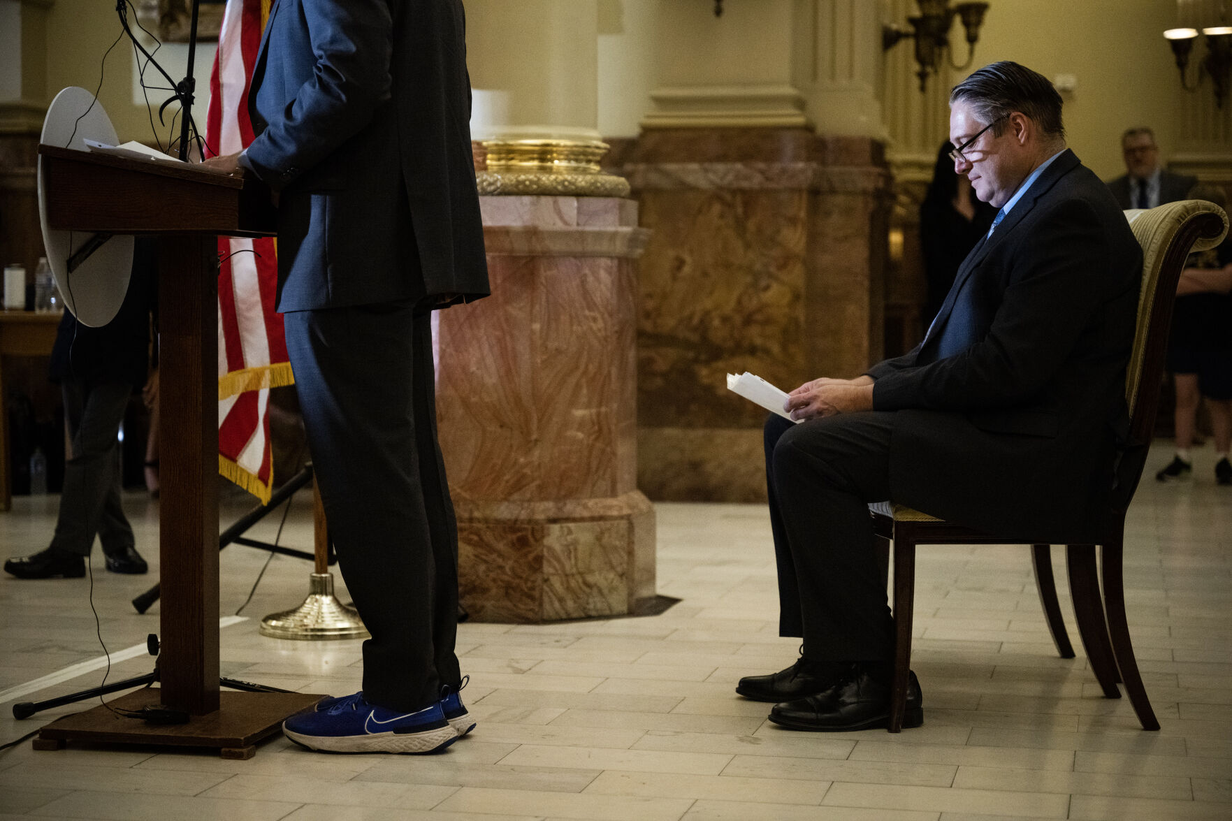 United States Citizenship and Immigration Services Kansas City district director David Douglas, right, waits to administer the Oath of Allegiance as Gov. Jared Polis gives remarks during a naturalization ceremony in the West Foyer of the Colorado State Capitol building on Tuesday, Aug. 1, 2023, in Denver, Colo. 35 new U.S. citizens from 20 different countries took the Oath during the ceremony, held at the Capitol in celebration of the 147th anniversary of President Ulysses S. Grant signing a proclamation that officially declared Colorado a state. (Timothy Hurst/Denver Gazette) (TimHursttim.hurst@gazette.comhttps://secure.gravatar.com/avatar/aca82bd62b4ee425c598527cd6faa1b1?d=mm&r=g)