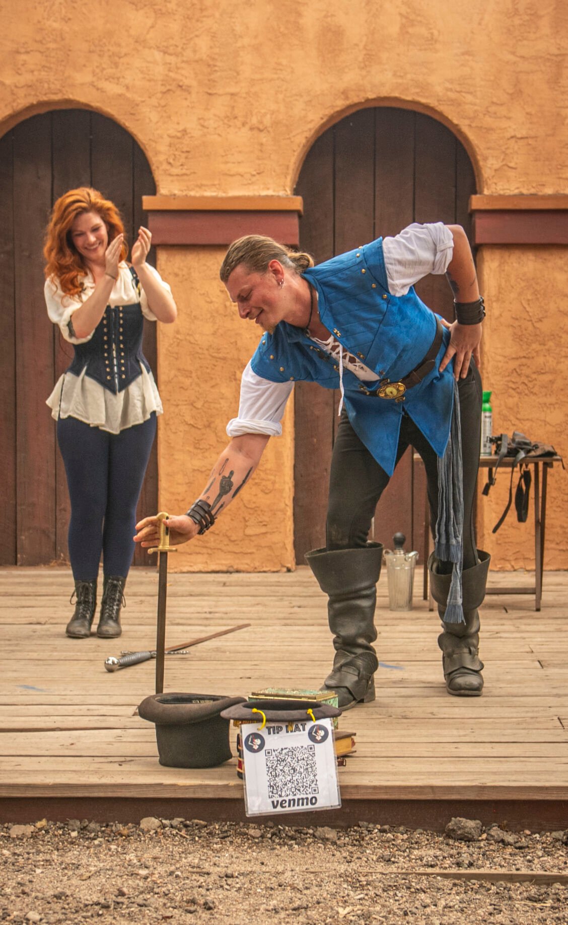 Sword swallower Cyrus Pynn throws down his swords after attempting to break the Guinness World Record for the longest time swallowing a sword while balancing another sword tip to pommel at the Colorado Renaissance Festival in Colorado Springs, Co., on Saturday, July 29, 2023. (Gabi Broekema)