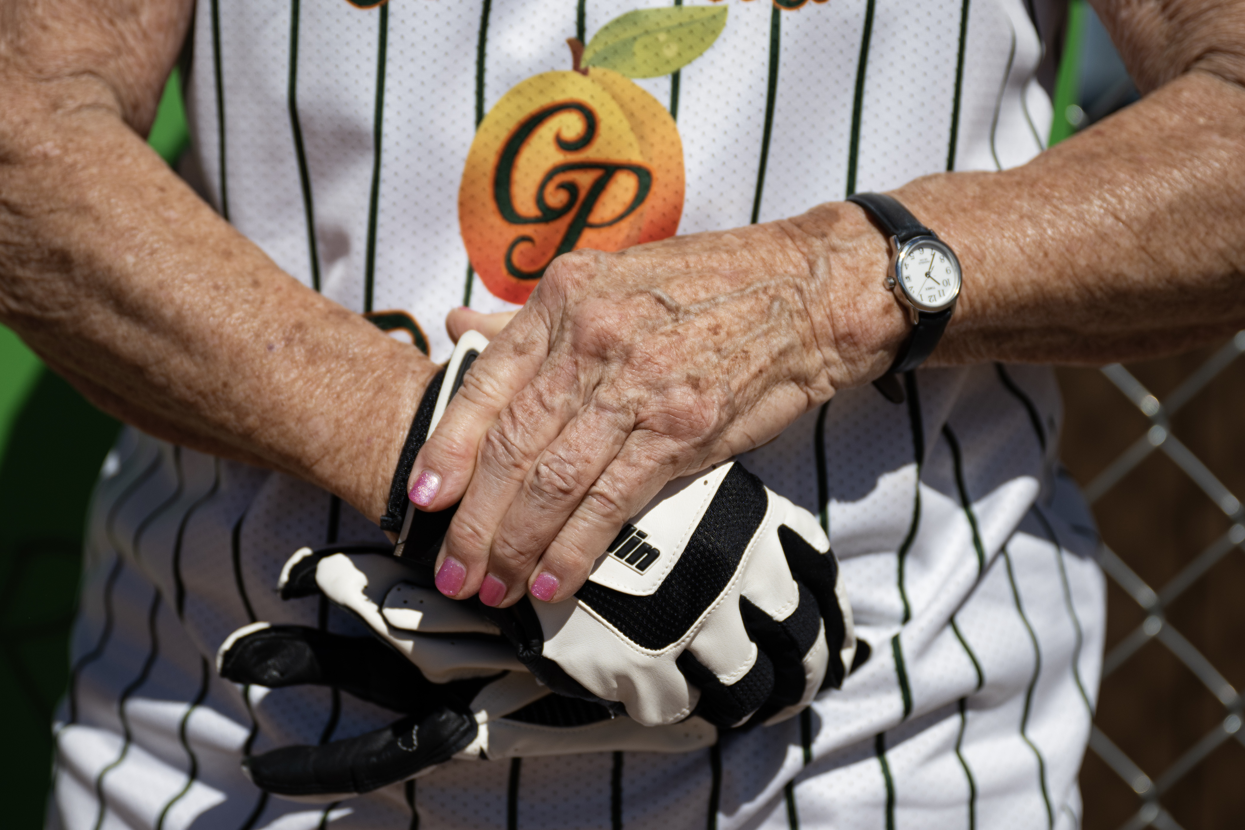 Colorado Peaches player Barbara “Mom” Johnson (24), playing for the Turnovers, straps on her batting loves before heading to the plate in a game against the Tarts during the Second Annual Gail Klock Memorial Peach Bowl on Tuesday, Aug. 29, 2023, at Addenbrooke Park in Lakewood, Colo. (Timothy Hurst/Denver Gazette) (TimHursttim.hurst@gazette.comhttps://secure.gravatar.com/avatar/aca82bd62b4ee425c598527cd6faa1b1?d=mm&r=g)