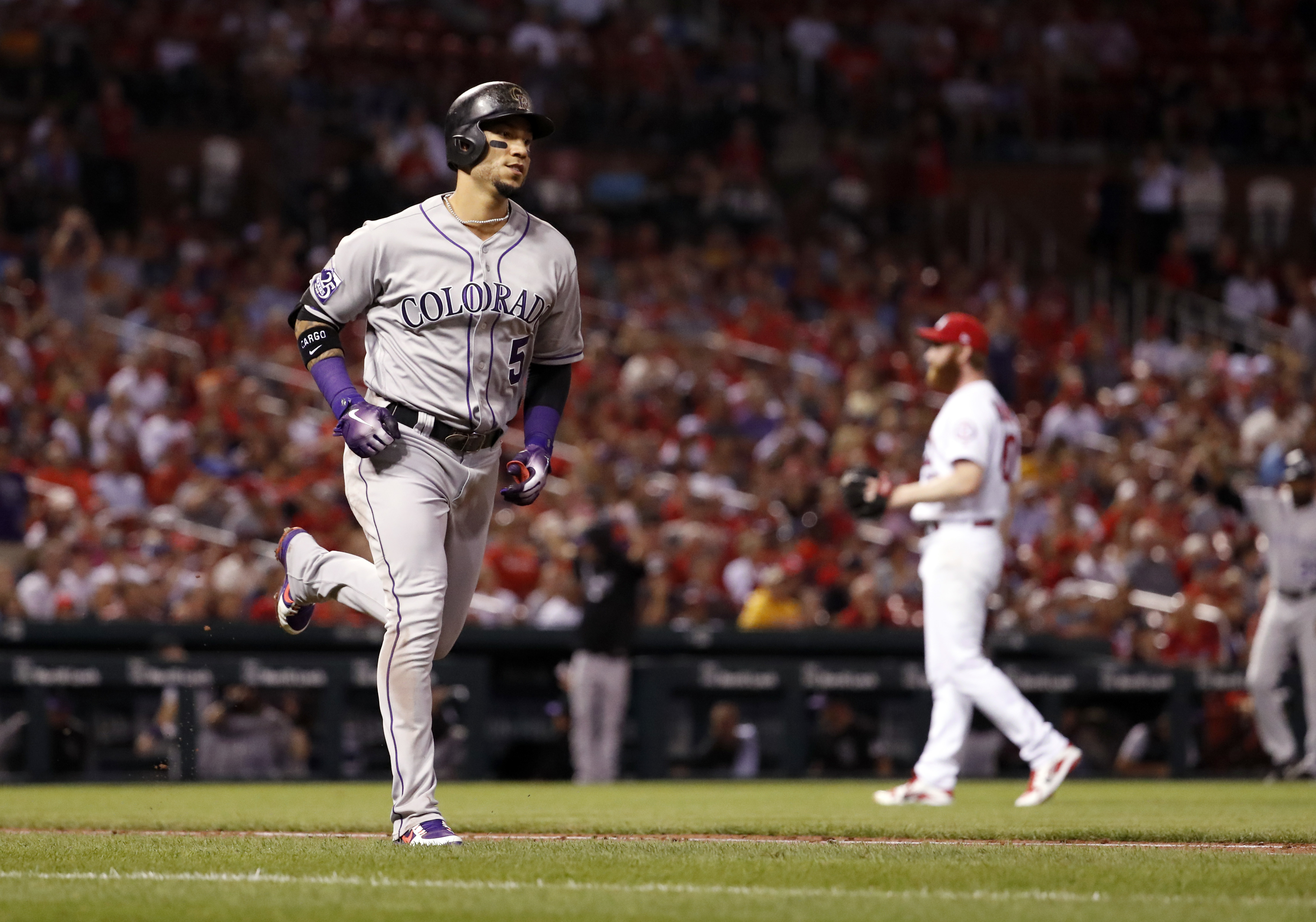 Colorado Rockies' Carlos Gonzalez, left, rounds the bases after hitting a two-run home run off St. Louis Cardinals relief pitcher John Brebbia during the seventh inning of a baseball game Tuesday, July 31, 2018, in St. Louis. (AP Photo/Jeff Roberson) (Jeff Roberson)