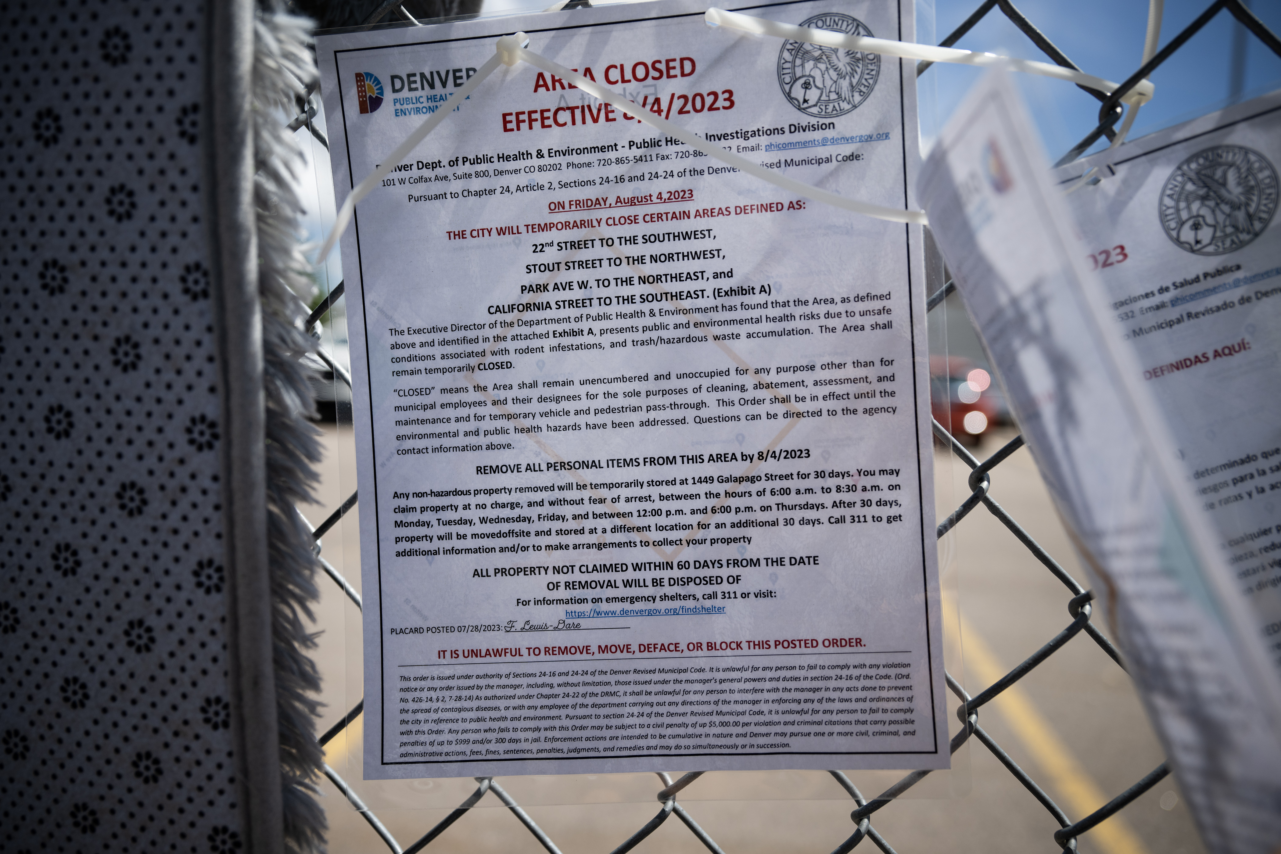One of many notices announcing the temporary closure of areas common used at encampments is posted to the fence at an encampment at 22nd Street and Stout Street on Thursday, Aug. 3, 2023, in Denver, Colo. (Timothy Hurst/Denver Gazette) (Timothy Hurst/Denver Gazette)