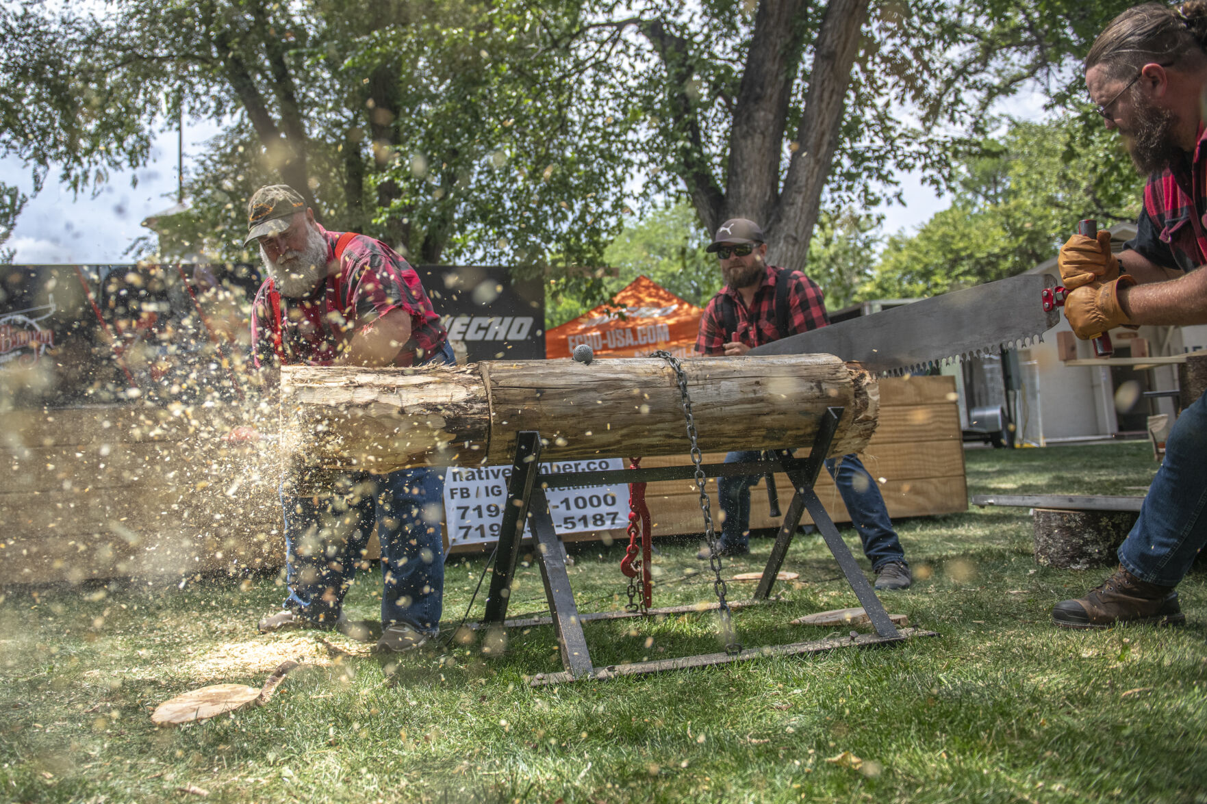 Owner of the Pual Bunyan Lumberjack Show Lee LeCapitan goes saws a log during his show on the first day of the Colorado State Fair in Pueblo, Colo. on Friday, August 25, 2023. (Gabi Broekema)