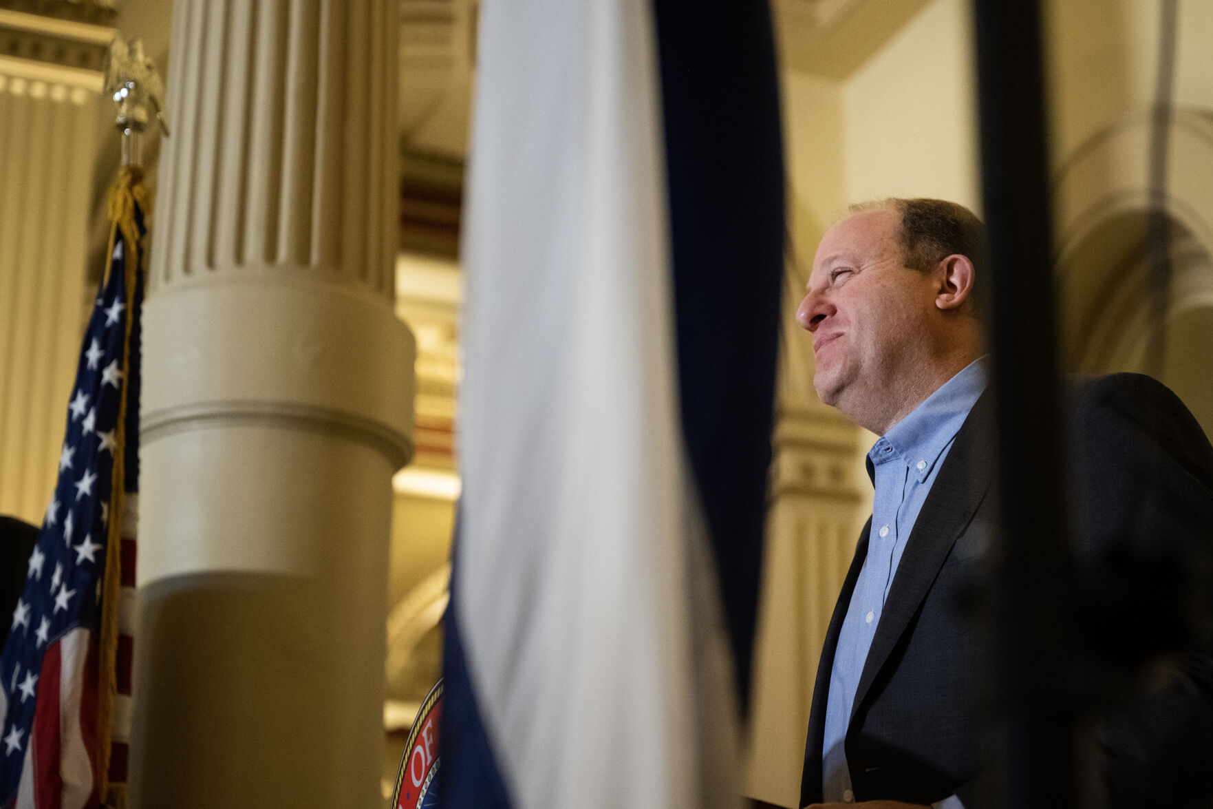Soon-to-be U.S. citizens look on as Gov. Jared Polis gives remarks during a naturalization ceremony in the West Foyer of the Colorado State Capitol building on Tuesday, Aug. 1, 2023, in Denver, Colo. 35 new U.S. citizens from 20 different countries took the Oath of Allegiance from United States Citizenship and Immigration Services Kansas City district director David Douglas, held at the Capitol in celebration of the 147th anniversary of President Ulysses S. Grant signing a proclamation that officially declared Colorado a state. (Timothy Hurst/Denver Gazette) (TimHursttim.hurst@gazette.comhttps://secure.gravatar.com/avatar/aca82bd62b4ee425c598527cd6faa1b1?d=mm&r=g)