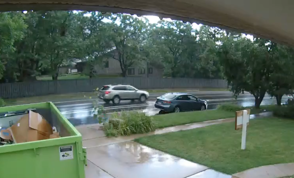 The video that's traveling down the road (not the car that's parked) is believed to be involved in the collision. Image: Boulder Police Department, released as video and captured by a Nest home security camera prior to the incident).