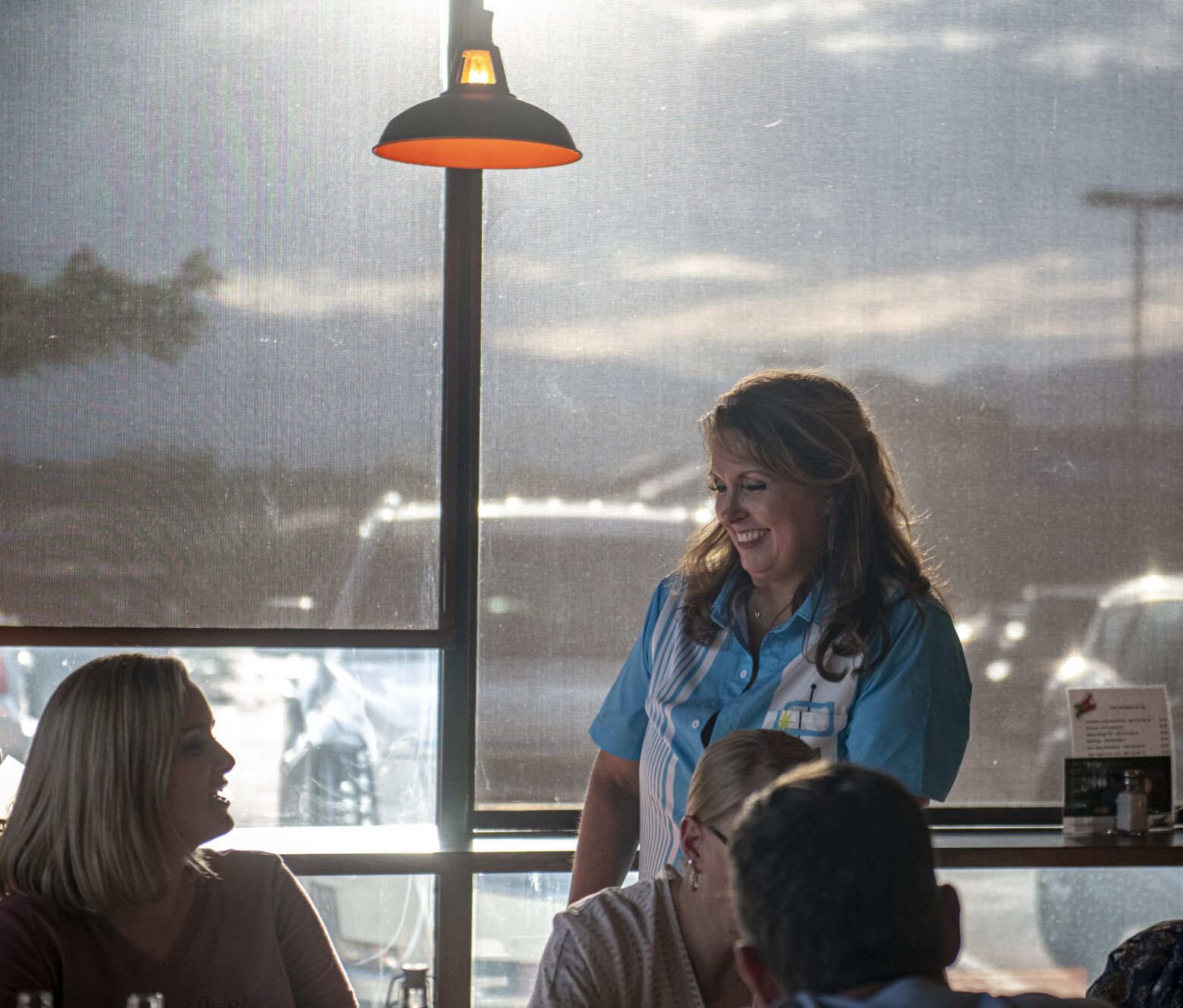 Lebowski's Taproom owner Monica Kowalski smiles with a customer at a table at her taproom in Colorado Springs, Colo. on Wednesday, August 23, 2023. (Gabi Broekema)