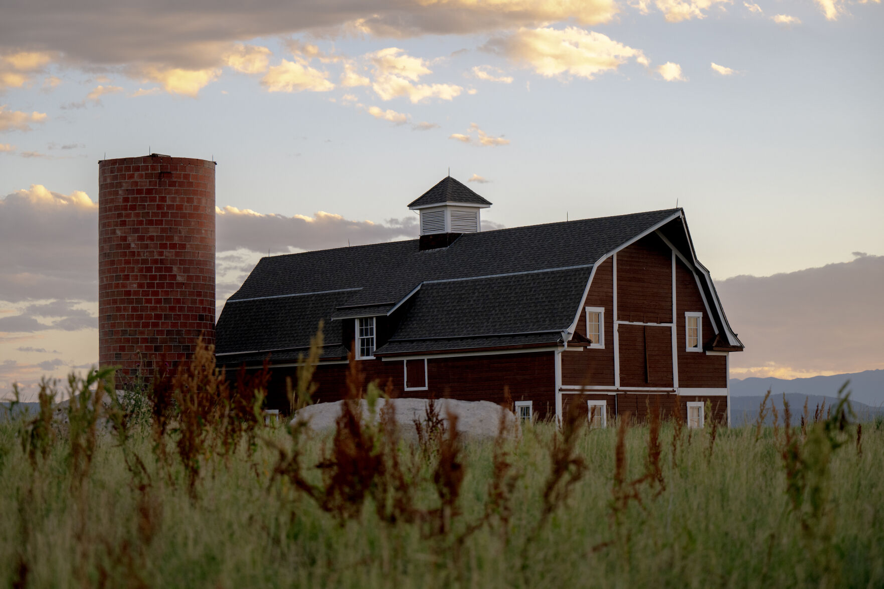 The restored barn and silo recalling socialite Florence Martin, a dear friend of William Cooke Daniels, can be seen sitting among tall grass from Daniels Park Road. (photos by Parker Seibold, The Gazette,)