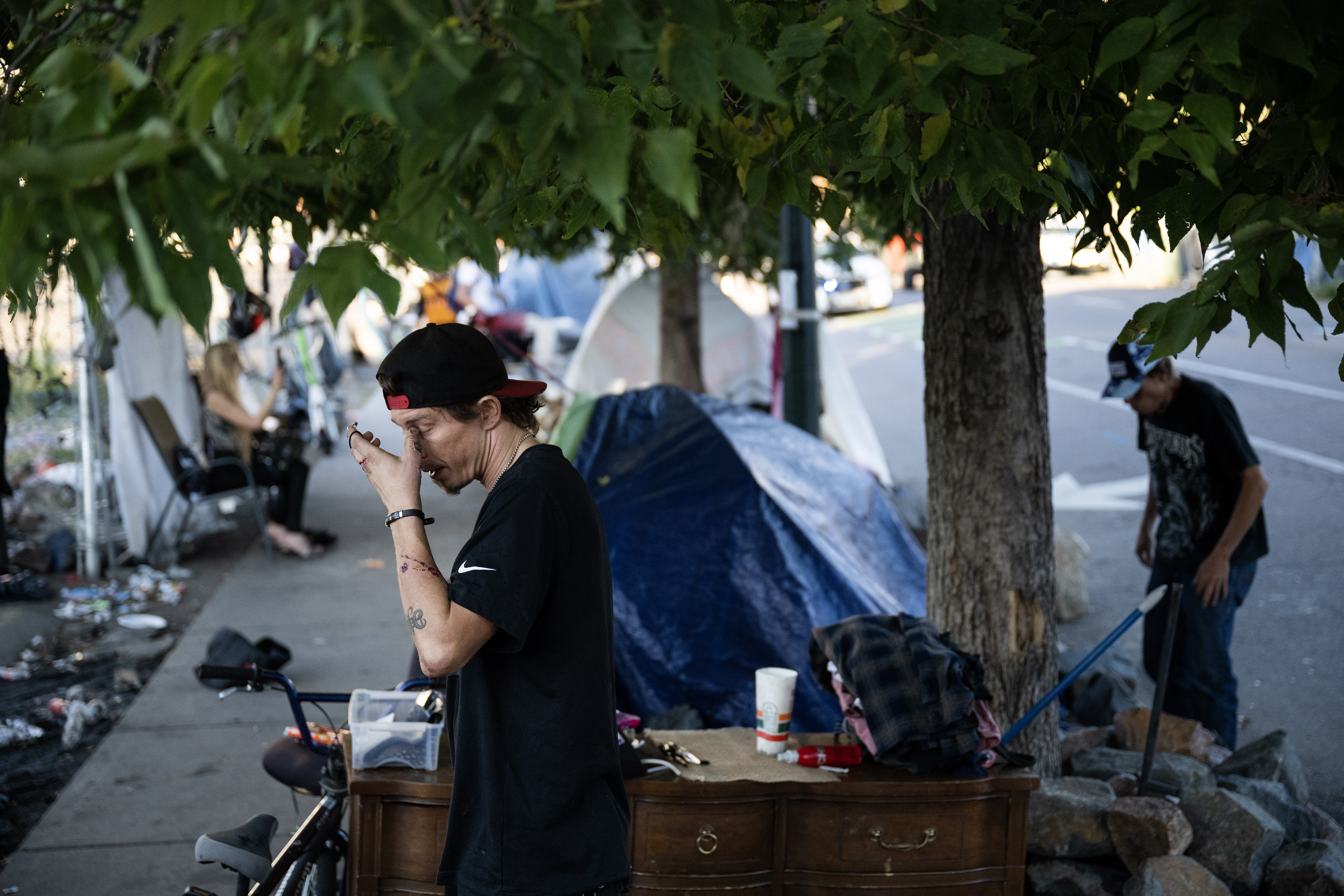 David Sjoberg rubs his eye while working to pack up his camp site as fast as possible before the first encampment sweep under the Johnston administration at an encampment at 22nd and Stout streets on Friday morning, Aug. 4, 2023, in Denver, Colo. (Timothy Hurst/Denver Gazette) (TimHursttim.hurst@gazette.comhttps://secure.gravatar.com/avatar/aca82bd62b4ee425c598527cd6faa1b1?d=mm&r=g)