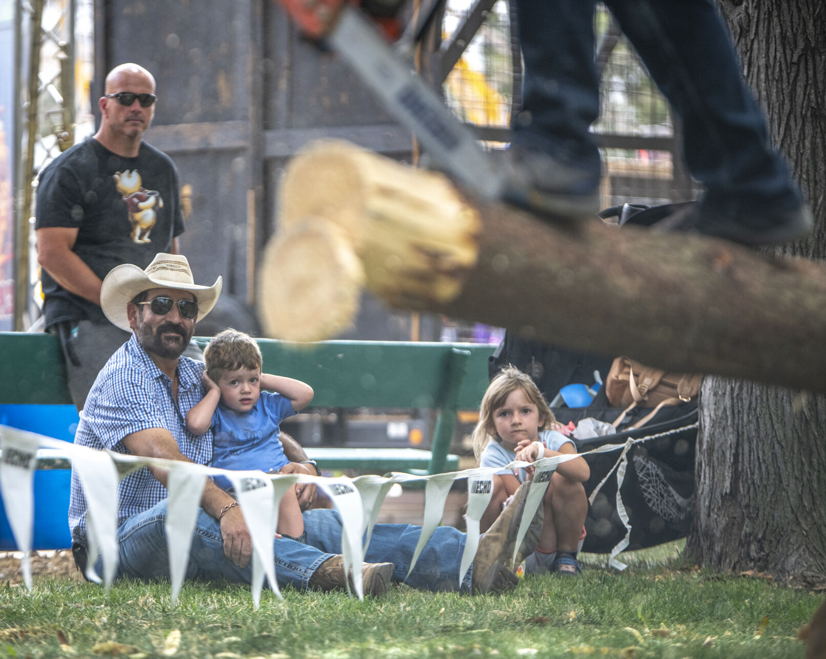 Jarrett Carleo, 3, of Grand Junction blocks out the round noise of the chainsaws during the Paul Bunyan Lumberjack Show at the Colorado State Fair in Pueblo, Colo. on Friday, August 25, 2023. He attended the show with his father Luke and sister Abby who was luck enough to get a chainsaw-carved mini chair for free during the show. (Gabi Broekema)