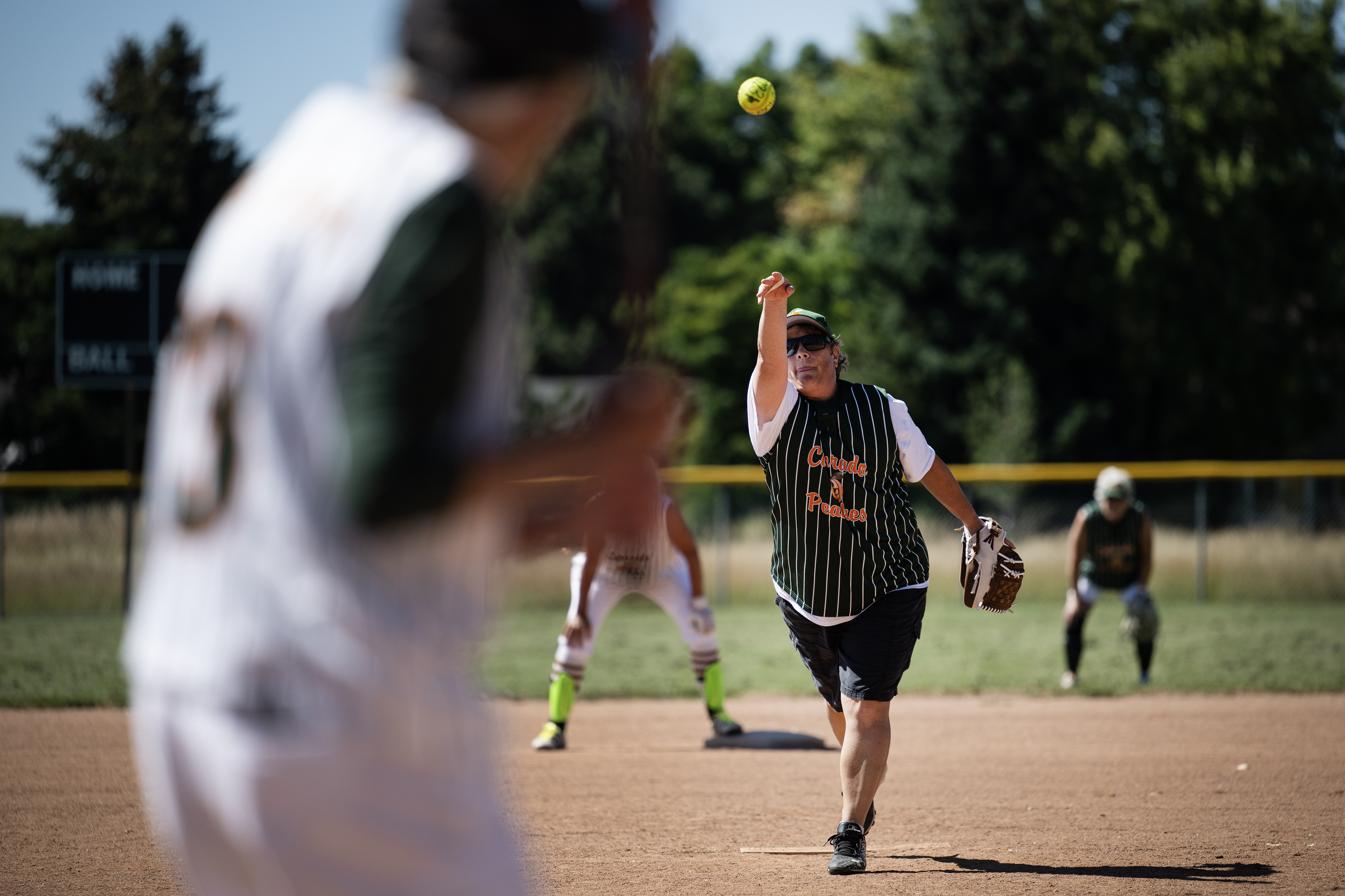 Colorado Peaches Tarts coach Heidi Muller (12) pitches to Turnovers batter “Maggie” McCloskey (13) during the Second Annual Gail Klock Memorial Peach Bowl on Tuesday, Aug. 29, 2023, at Addenbrooke Park in Lakewood, Colo. (Timothy Hurst/Denver Gazette) (TimHursttim.hurst@gazette.comhttps://secure.gravatar.com/avatar/aca82bd62b4ee425c598527cd6faa1b1?d=mm&r=g)