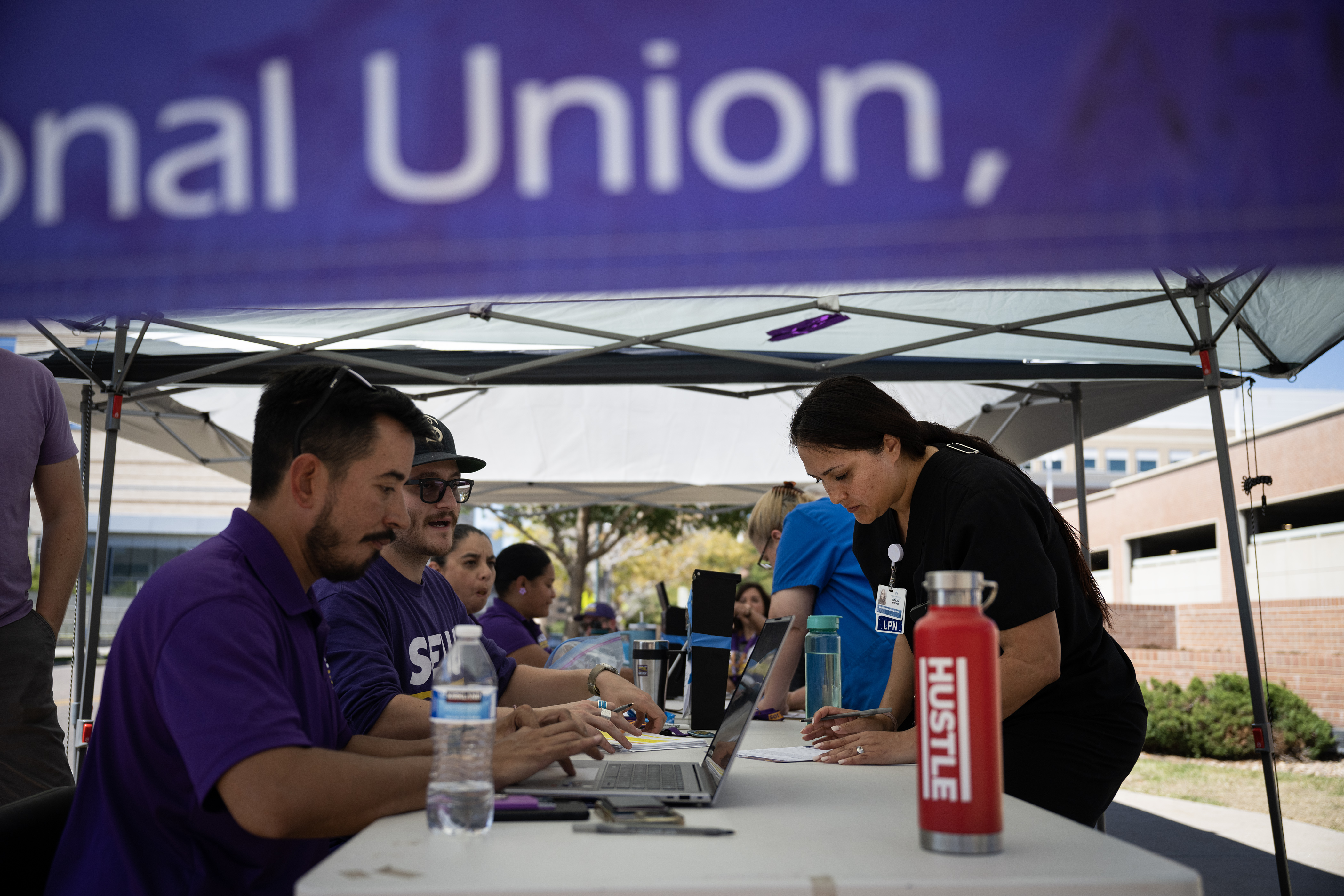 Kaiser Permanente licensed practical nurse Angelica Martinez, right, casts her vote to either authorize a strike or not at a tent set up by Service Employees International Union Local 105 Denver, outside of the Kaiser Permanente Franklin Medical Offices on Thursday, Aug. 31, 2023, in Denver. (Timothy Hurst/Denver Gazette) (TimHursttim.hurst@gazette.comhttps://secure.gravatar.com/avatar/aca82bd62b4ee425c598527cd6faa1b1?d=mm&r=g)