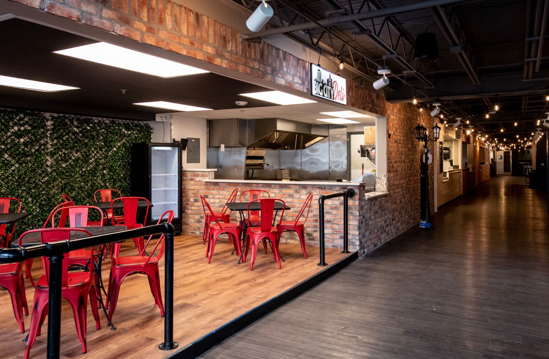 At 19 N. Tejon St., the space formerly known as the Tejon Eatery, gray and white walls have been replaced with brick and wood, overhead lights have been replaced with strands of string lights lining the hallway and artificial plants are starting to cover the walls, all with a goal to transform the 26,000-square-foot food hall into an outdoor courtyard themed food hub, entertainment spot and bar scene called Avenue 19. (Parker Seibold, The Gazette)