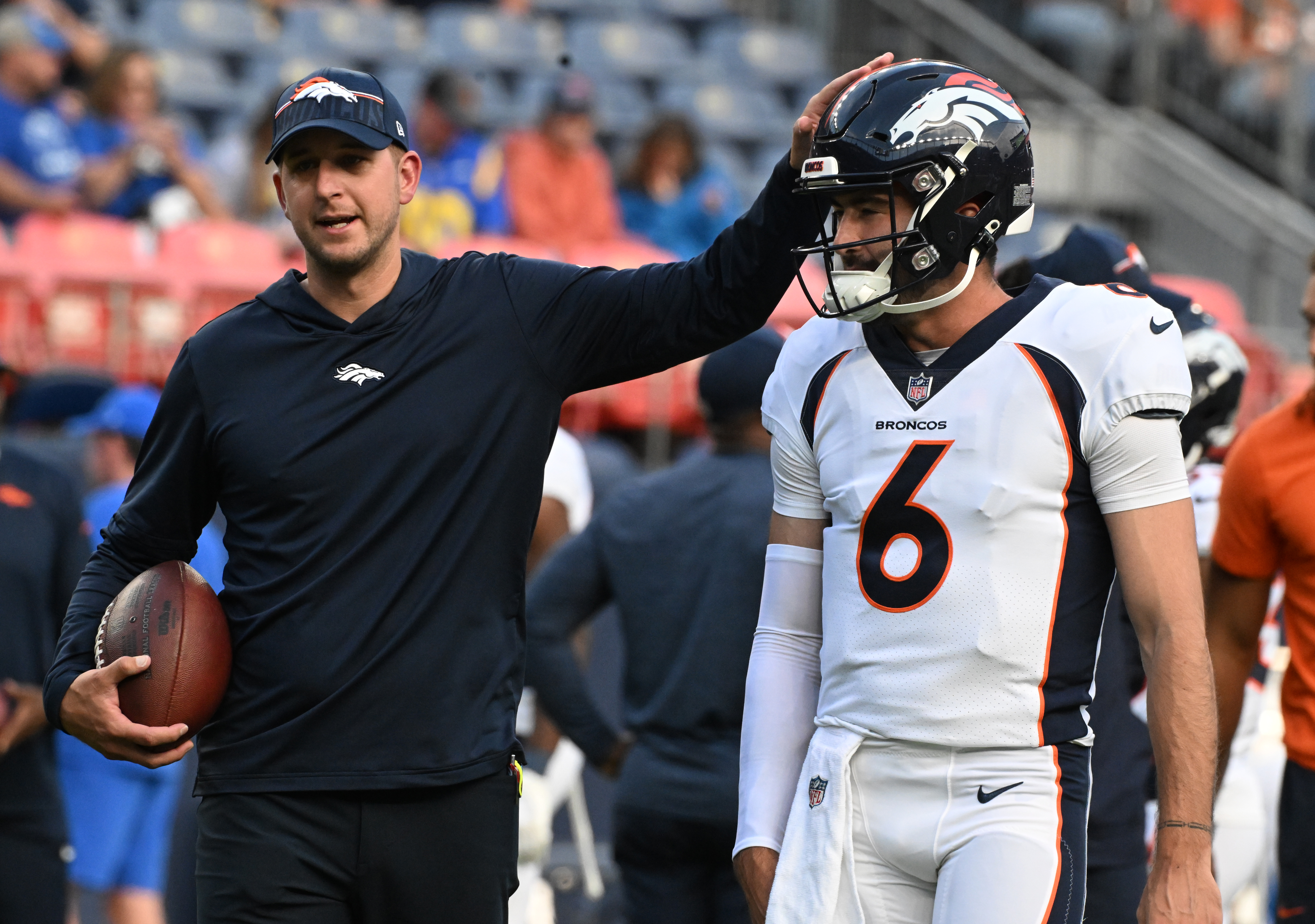 Broncos quarterback Ben DiNucci gets a pat on the head during warmups. The Broncos beat the Rams 41-0 in the final preseason game at Empower Field at Mile High on Saturday, Aug. 26, 2023. (Photo by Jerilee Bennett, The Gazette)