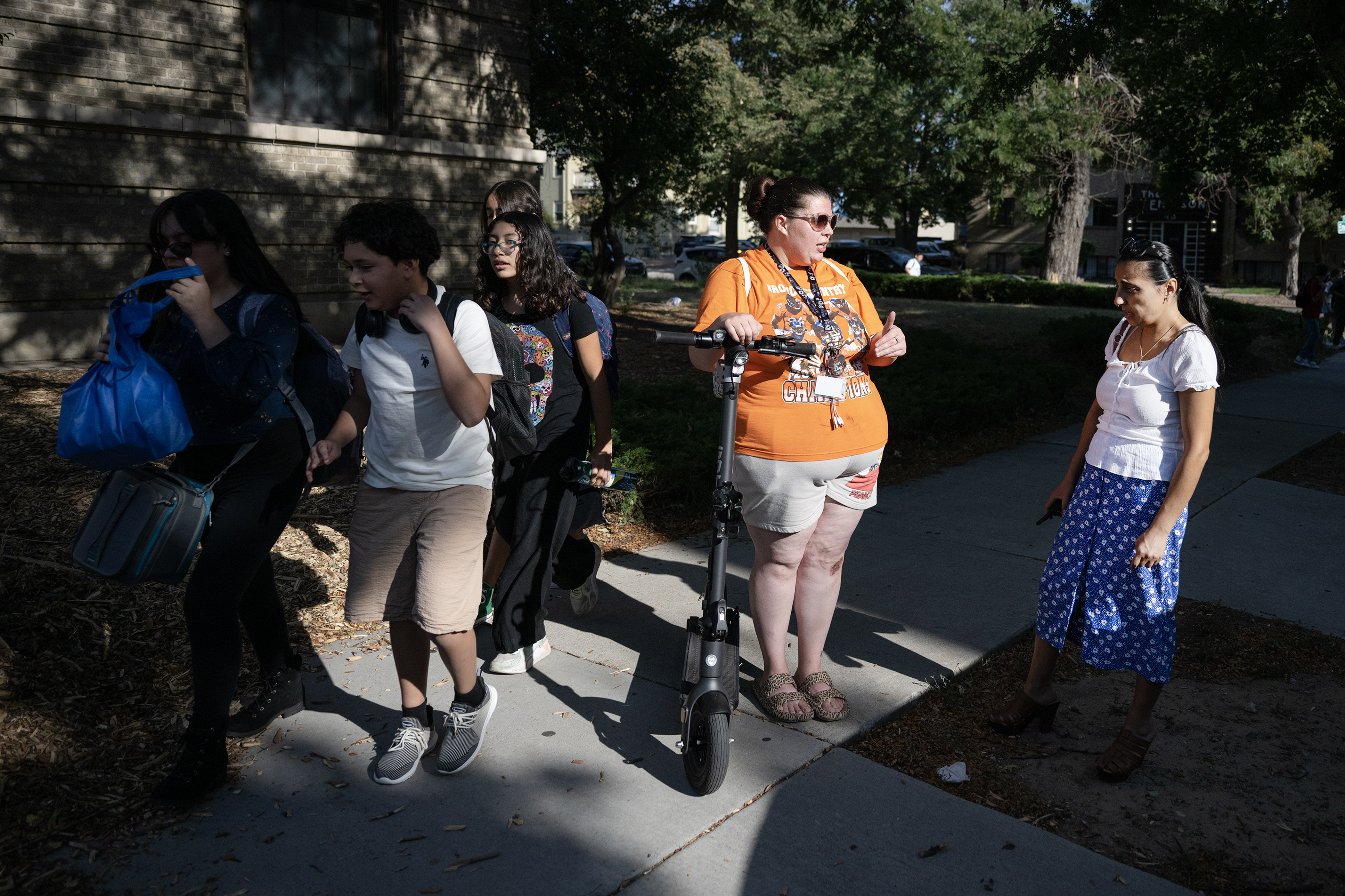 Parents Dallas Rael, left, and Janna Steele discuss the lack of bus service to Morey Middle School after dropping their kids off for the day on Tuesday, Aug. 22, 2023, in Denver, Colo. Rael took her son William, a sixth grader at Morey, to school by riding RTD and then riding an electric scooter together for the last stint of the commute. (Timothy Hurst/Denver Gazette) (TimHursttim.hurst@gazette.comhttps://secure.gravatar.com/avatar/aca82bd62b4ee425c598527cd6faa1b1?d=mm&r=g)