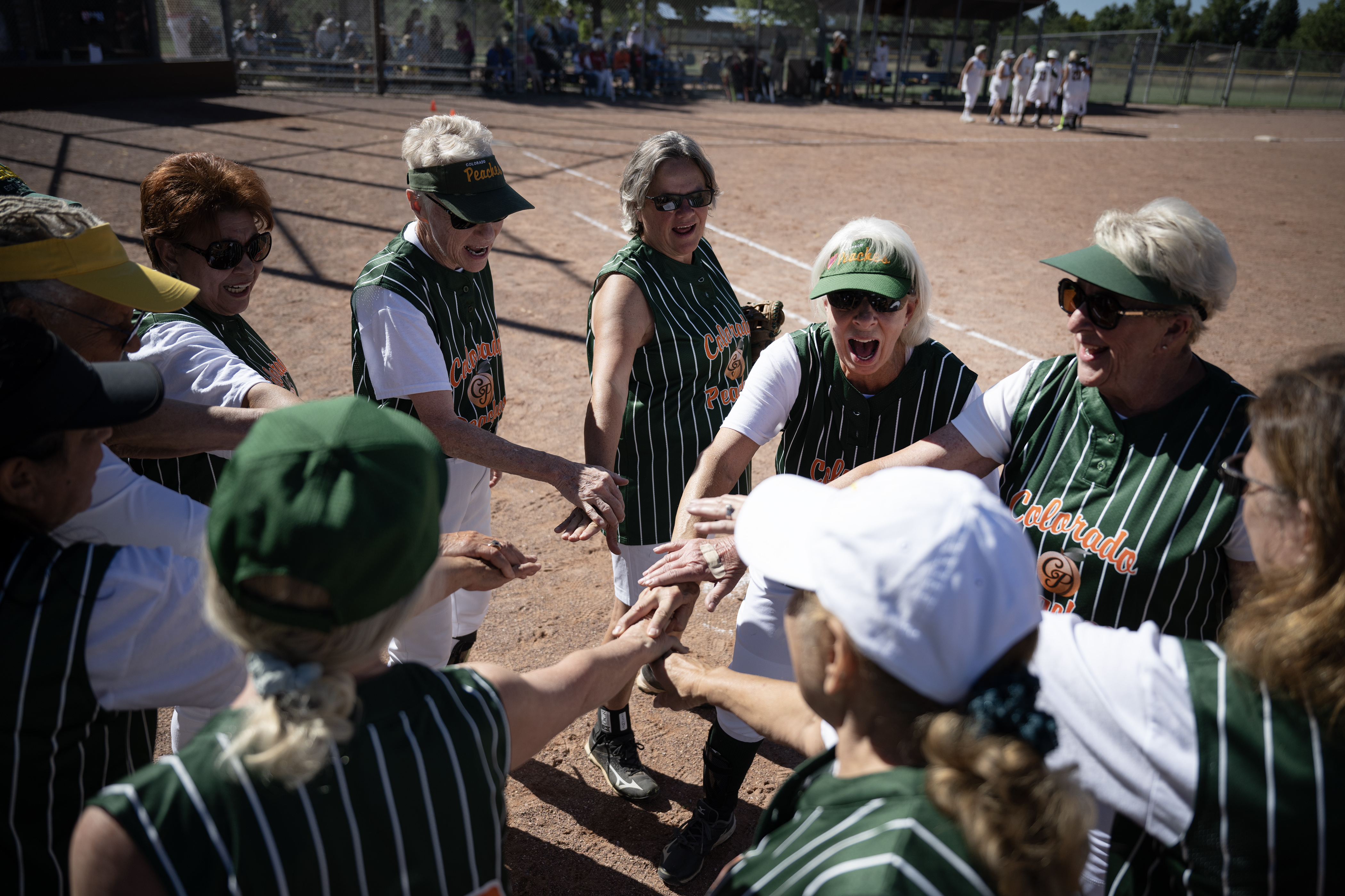 Colorado Peaches Pies players huddle up after a game against the Turnovers during the Second Annual Gail Klock Memorial Peach Bowl on Tuesday, Aug. 29, 2023, at Addenbrooke Park in Lakewood, Colo. (Timothy Hurst/Denver Gazette) (TimHursttim.hurst@gazette.comhttps://secure.gravatar.com/avatar/aca82bd62b4ee425c598527cd6faa1b1?d=mm&r=g)