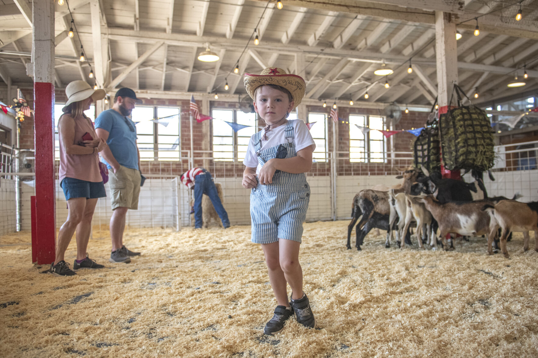 Nicholas VanderPutten, 4, has grown to love the Great American Petting Zoo of the Colorado State Fair in Pueblo, Colo. on Friday, August 25, 2023. In previous years of attending the fair, he was too terrified to even go near the pen, but now he cautiously pets the array of animals. (Gabi Broekema)