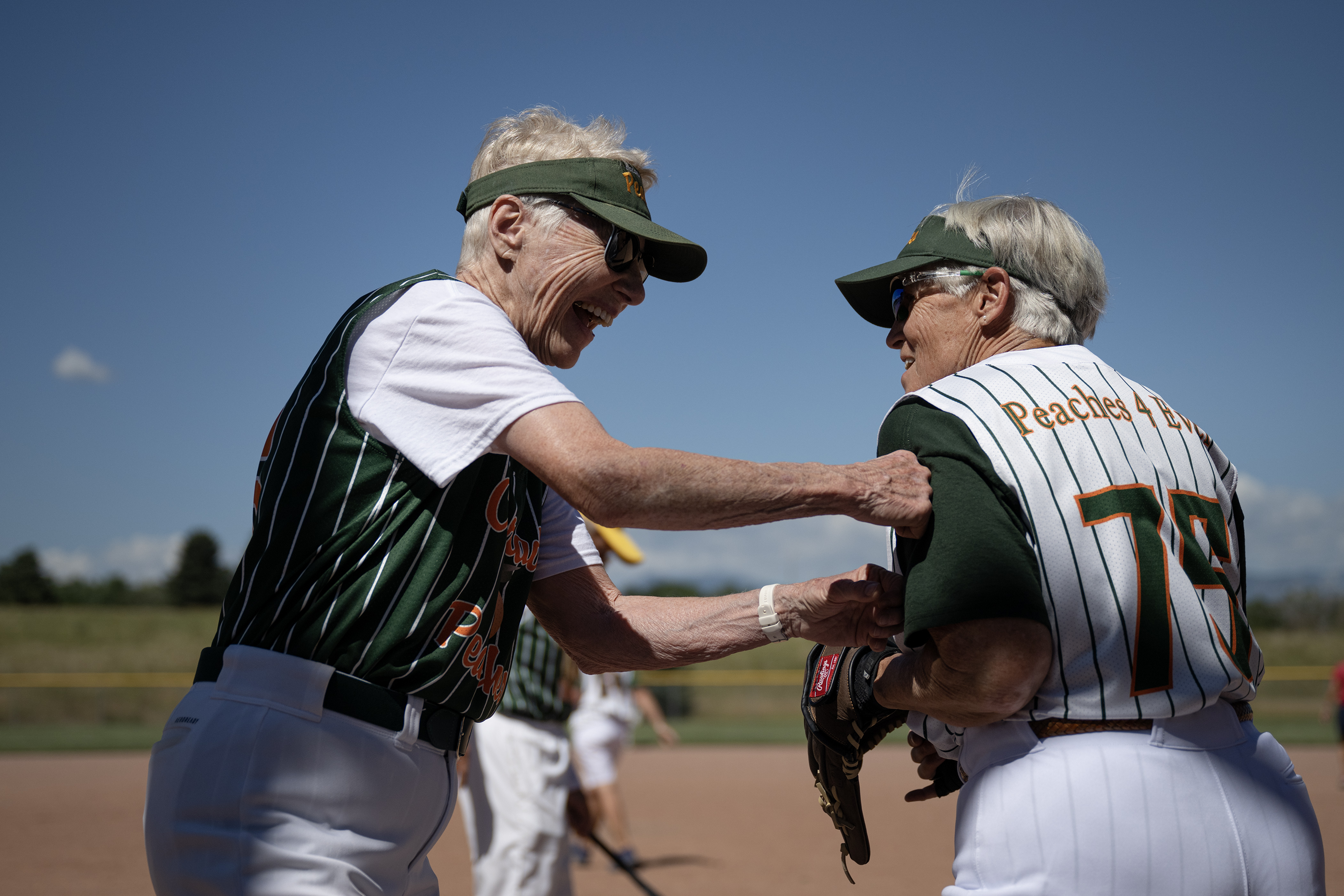 Colorado Peaches Pies player “Red Sue” Stantejsky (56) jokingly punches Schnapps player Cindy Babb’s shoulder after their game at the Second Annual Gail Klock Memorial Peach Bowl on Tuesday, Aug. 29, 2023, at Addenbrooke Park in Lakewood, Colo. (Timothy Hurst/Denver Gazette) (TimHursttim.hurst@gazette.comhttps://secure.gravatar.com/avatar/aca82bd62b4ee425c598527cd6faa1b1?d=mm&r=g)