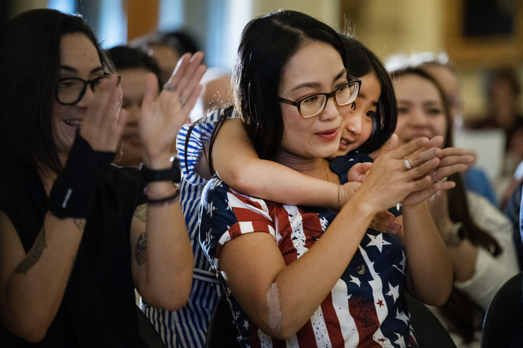 Maile Imada, 7, hugs her mother Vy Bui, originally from Vietnam, at the end of a naturalization ceremony at the Colorado State Capitol building on Tuesday, Aug. 1, 2023, in Denver, Colo. 35 new U.S. citizens from 20 different countries took the Oath of Allegiance from United States Citizenship and Immigration Services Kansas City district director David Douglas, held at the Capitol in celebration of the 147th anniversary of President Ulysses S. Grant signing a proclamation that officially declared Colorado a state. (Timothy Hurst/Denver Gazette) (TimHursttim.hurst@gazette.comhttps://secure.gravatar.com/avatar/aca82bd62b4ee425c598527cd6faa1b1?d=mm&r=g)