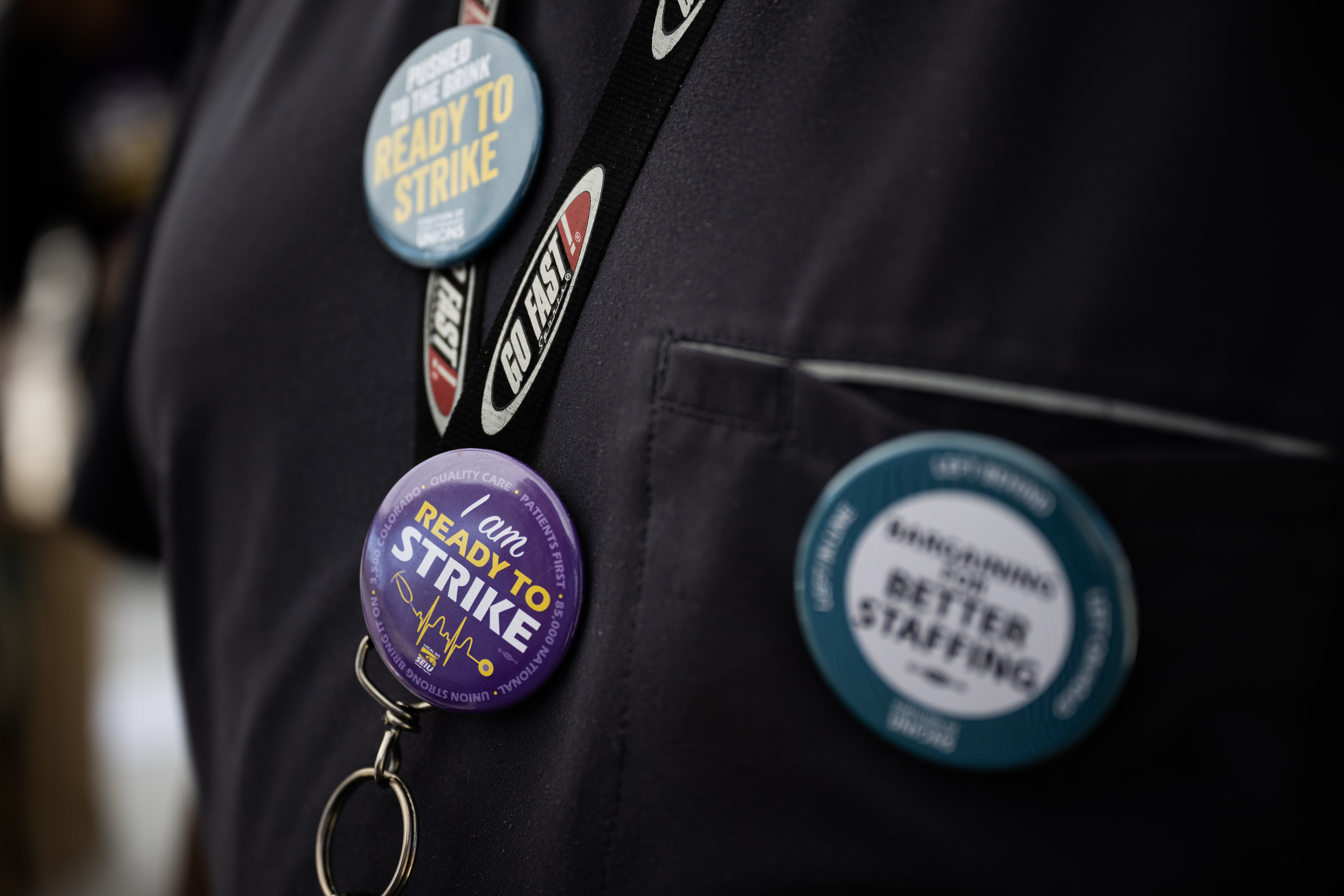 Kaiser Permanente orthopedic technician Lawrence Chapman wears multiple pins on his lanyard expressing his willingness to strike for better working conditions after casting his vote to either authorize a strike or not at a voting tent set up by Service Employees International Union Local 105 Denver, outside of the Kaiser Permanente Franklin Medical Offices on Thursday, Aug. 31, 2023, in Denver. (Timothy Hurst/Denver Gazette) (TimHursttim.hurst@gazette.comhttps://secure.gravatar.com/avatar/aca82bd62b4ee425c598527cd6faa1b1?d=mm&r=g)