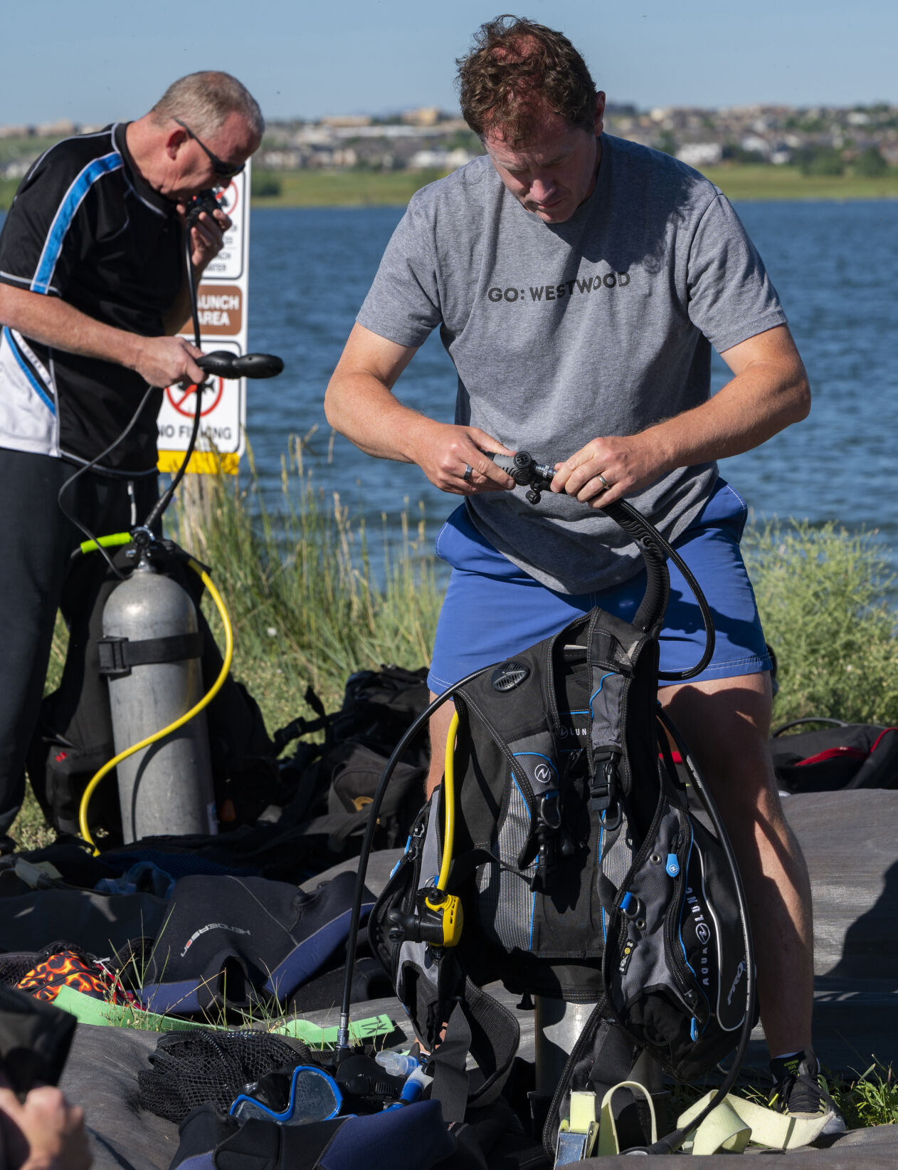 Rich Wilson checks his scuba equipment before going into the water Sunday, July 16, 2023, during a beginners diving class at Aurora Reservoir near Denver. (The Gazette, Christian Murdock) (Christian Murdock/The Gazette)