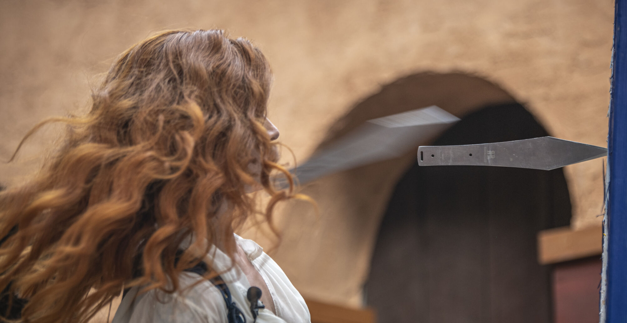 Sarah Bonnie dodges throwing knives at the Colorado Renaissance Festival in Colorado Springs, Co., on Saturday, July 29, 2023. (Gabi Broekema)