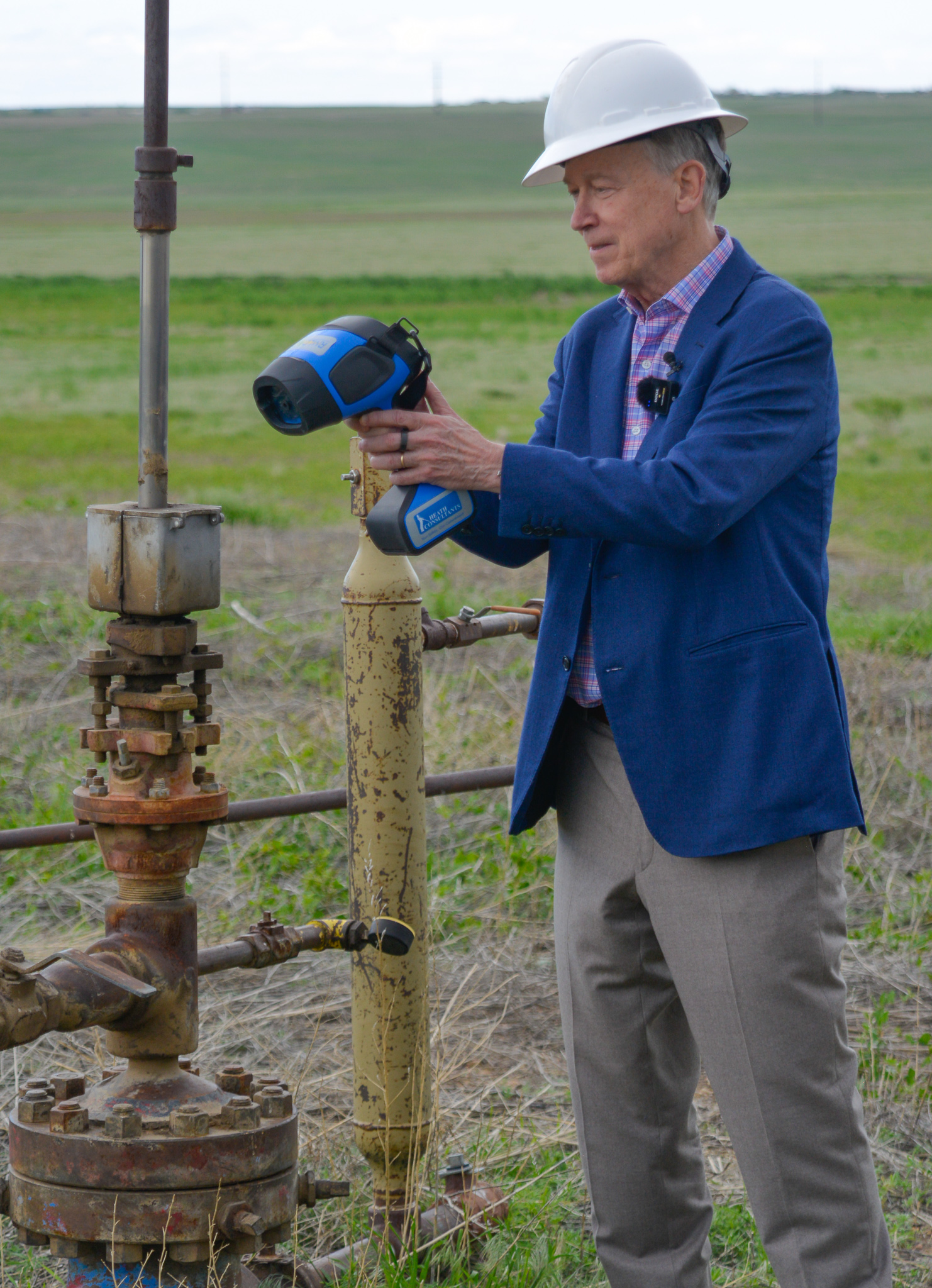 Colorado Senator John Hickenlooper uses a laser device to detect methane leakage from an abandoned oil well in Adams County
