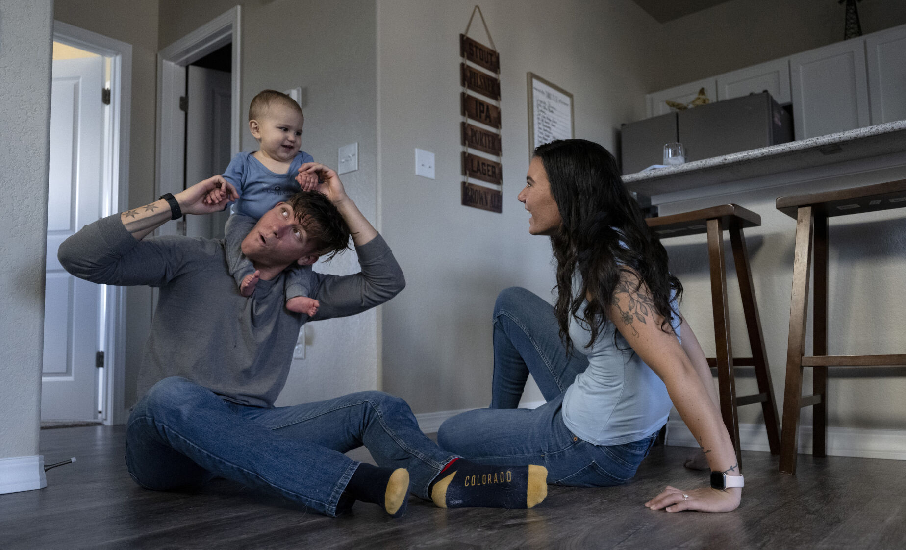 Zenen ”Z” Cardenas and Sarah Swan play with their 9-month-old son, Mateo Cardenas, before dinner last week. Cardenas and Swan were seniors at the Air Force Academy when Mateo was born. Cardenas graduated last spring, and Swan is finishing this school year. (Christian Murdock, The Gazette)