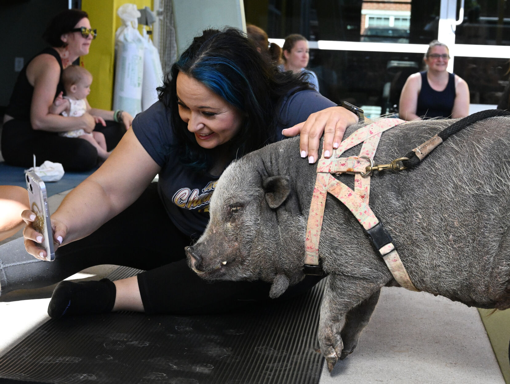 Lisette Perez does a selfie with Baron before pig yoga at Seedstock Brewery on Sunday, July 16, 2023. They are from Hog Haven Farm, a rescue for pigs. (Photo by Jerilee Bennett, The Gazette) (JERILEE BENNETT THE GAZETTE)
