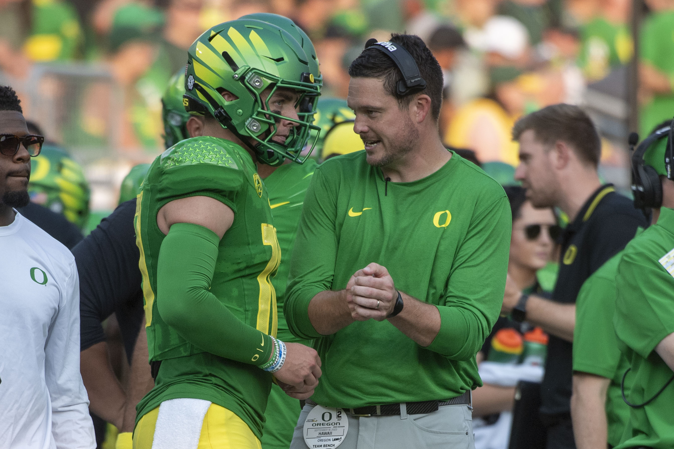 Oregon coach Dan Lanning talks with quarterback Bo Nix (10) after a scoring drive against Hawaii during the first half of an NCAA college football game Saturday, Sept. 16, 2023, in Eugene, Ore. (AP Photo/Andy Nelson) (Andy Nelson)