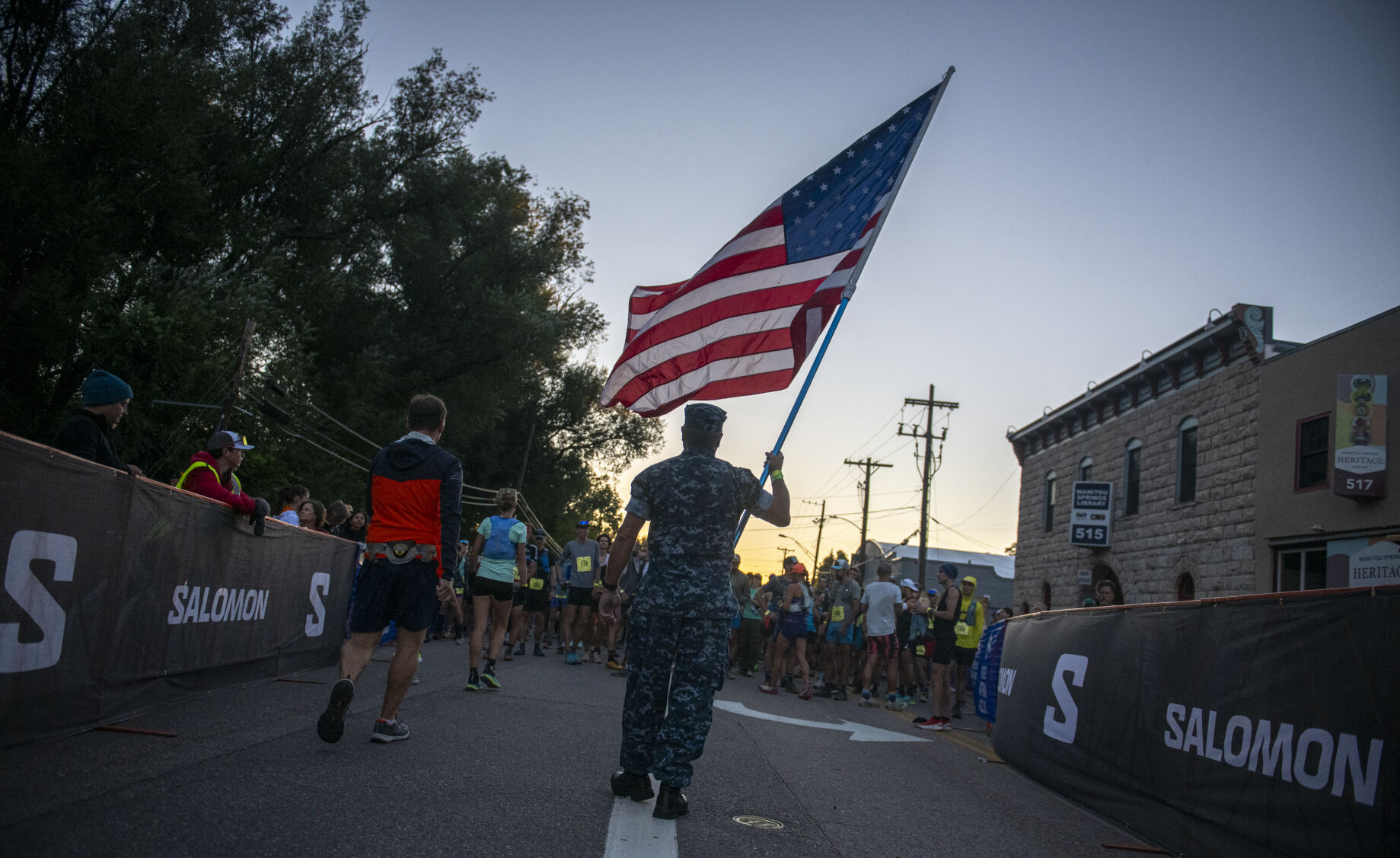 Pikes Peak Marathon runner Randy Woodward of Nashville, Tn., holds the American flag up for the singing of American the Beautiful in Manitou Springs on Sunday, September 17, 2023. (Gabi Broekema)