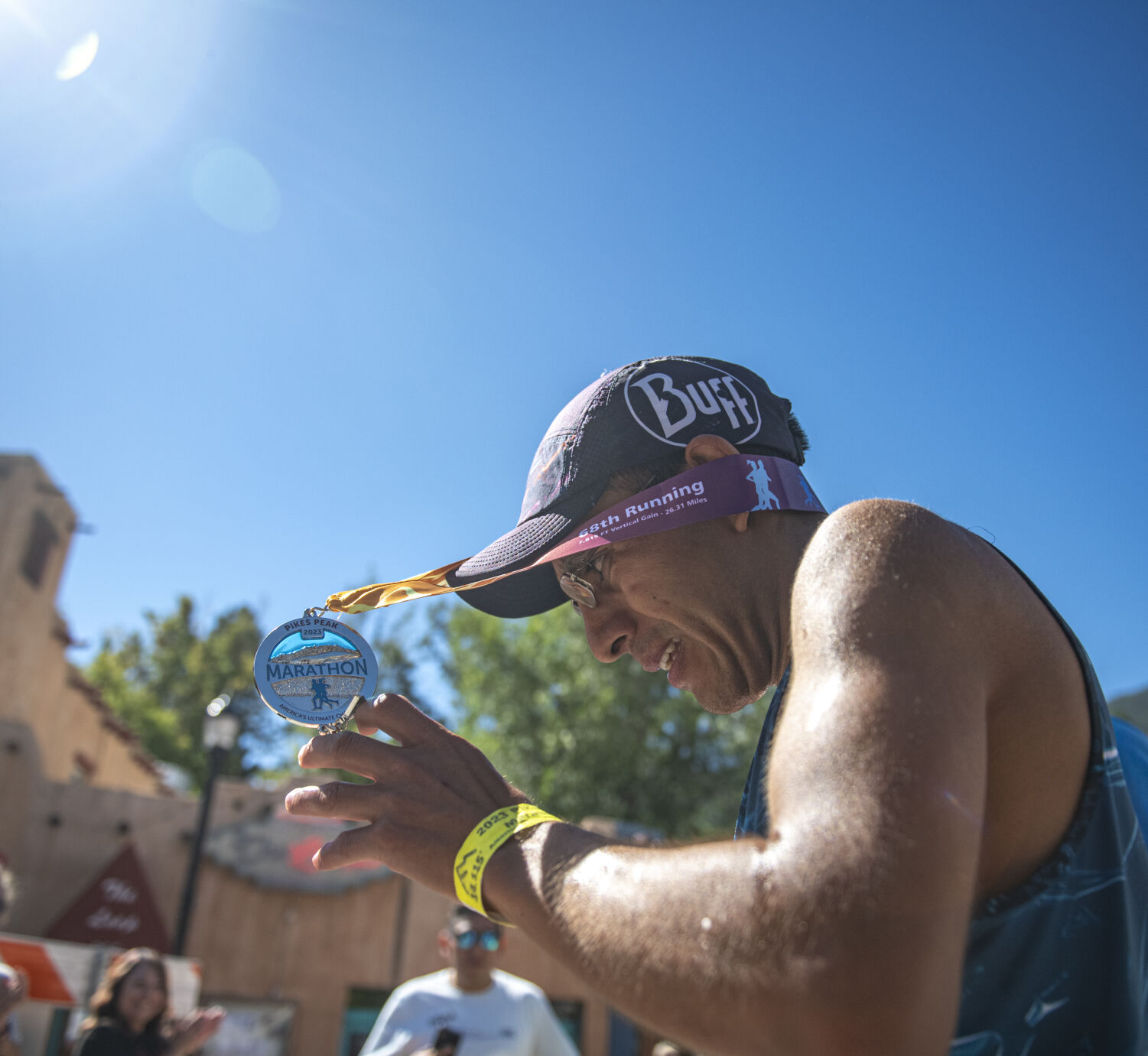 Pikes Peak Marathon 2023 3rd placer Hector Rene Rodriguez Barragan puts on the completion medal at the finish line in Manitou Springs on Sunday, September 17, 2023. (Gabi Broekema)