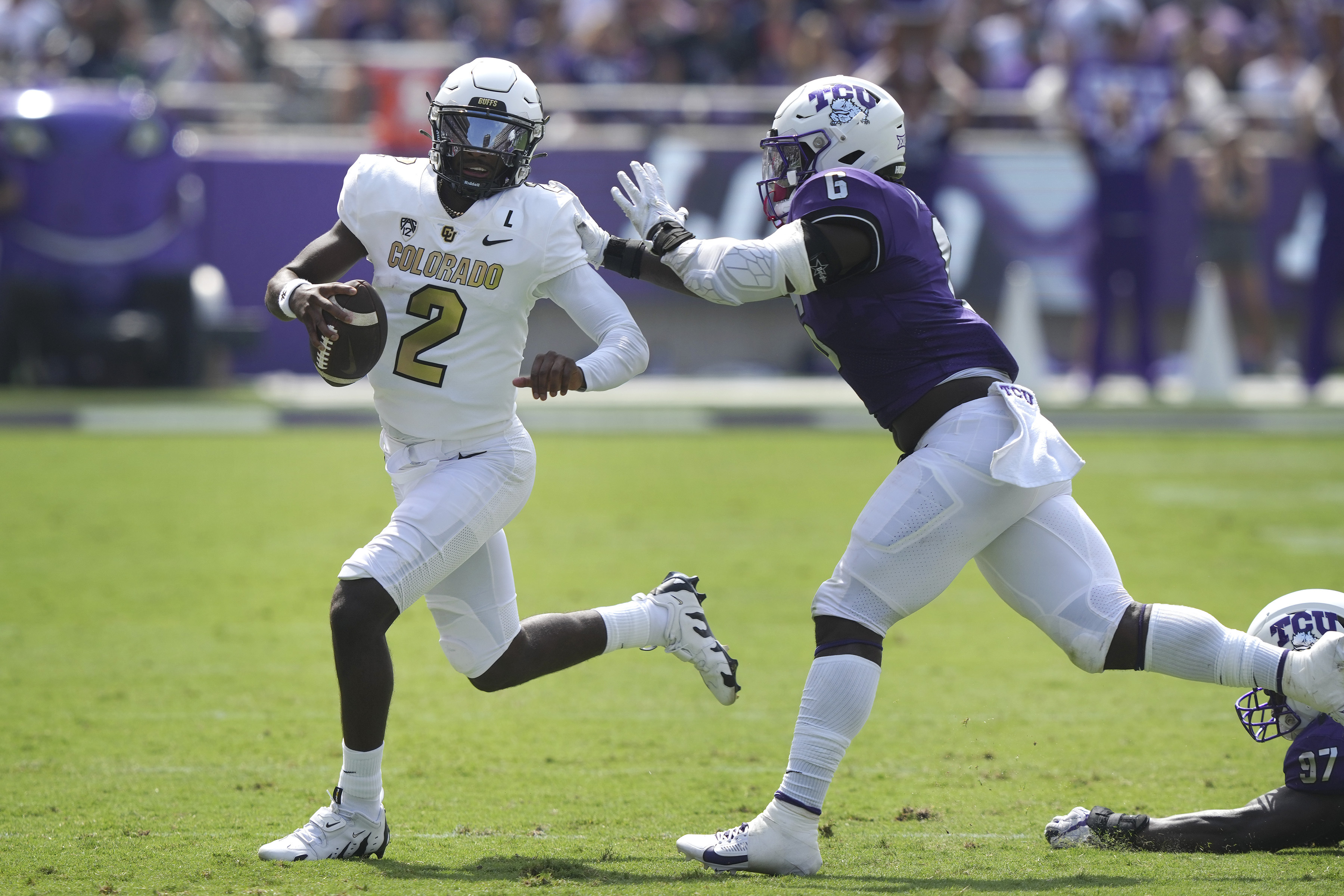 Colorado quarterback Shedeur Sanders (2) runs from TCU linebacker Jamoi Hodge (6) during the first half of an NCAA college football game Saturday, Sept. 2, 2023, in Fort Worth, Texas. (AP Photo/LM Otero) (LM Otero)