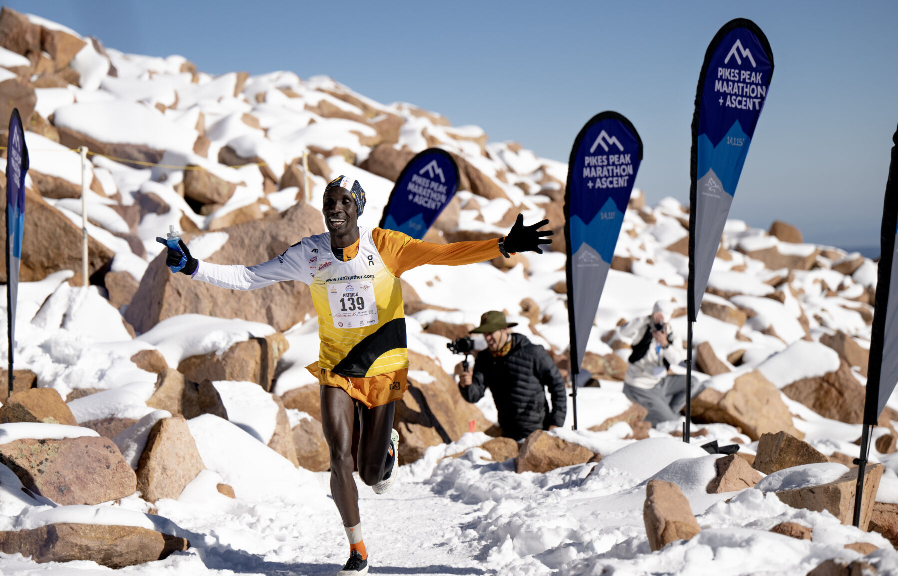 Kenyan runners Patrick Kipngeno celebrates as he approaches the finish line of the Pikes Peak Ascent on Saturday, Sept. 16, 2023. Kipngeno finished second overall in the race. (Parker Seibold, The Gazette) (Parker Seibold)