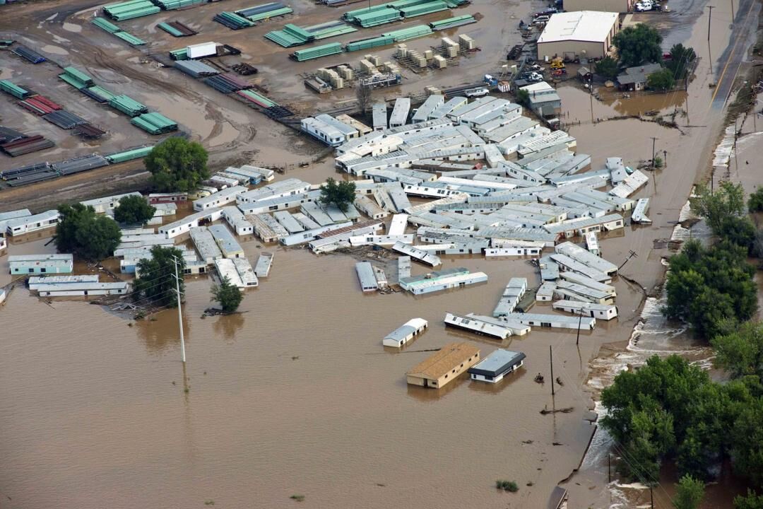 FILE PHOTO: A group of trailers are smashed together at a storage site near Greeley, Colo., Saturday, Sept. 14, 2013, as debris-filled rivers flooded into towns and farms miles from the Rockies. Hundreds of roads, farms and businesses in the area have been damaged or destroyed by the floodwaters. (AP Photo/John Wark) (John Wark/Associated Press)