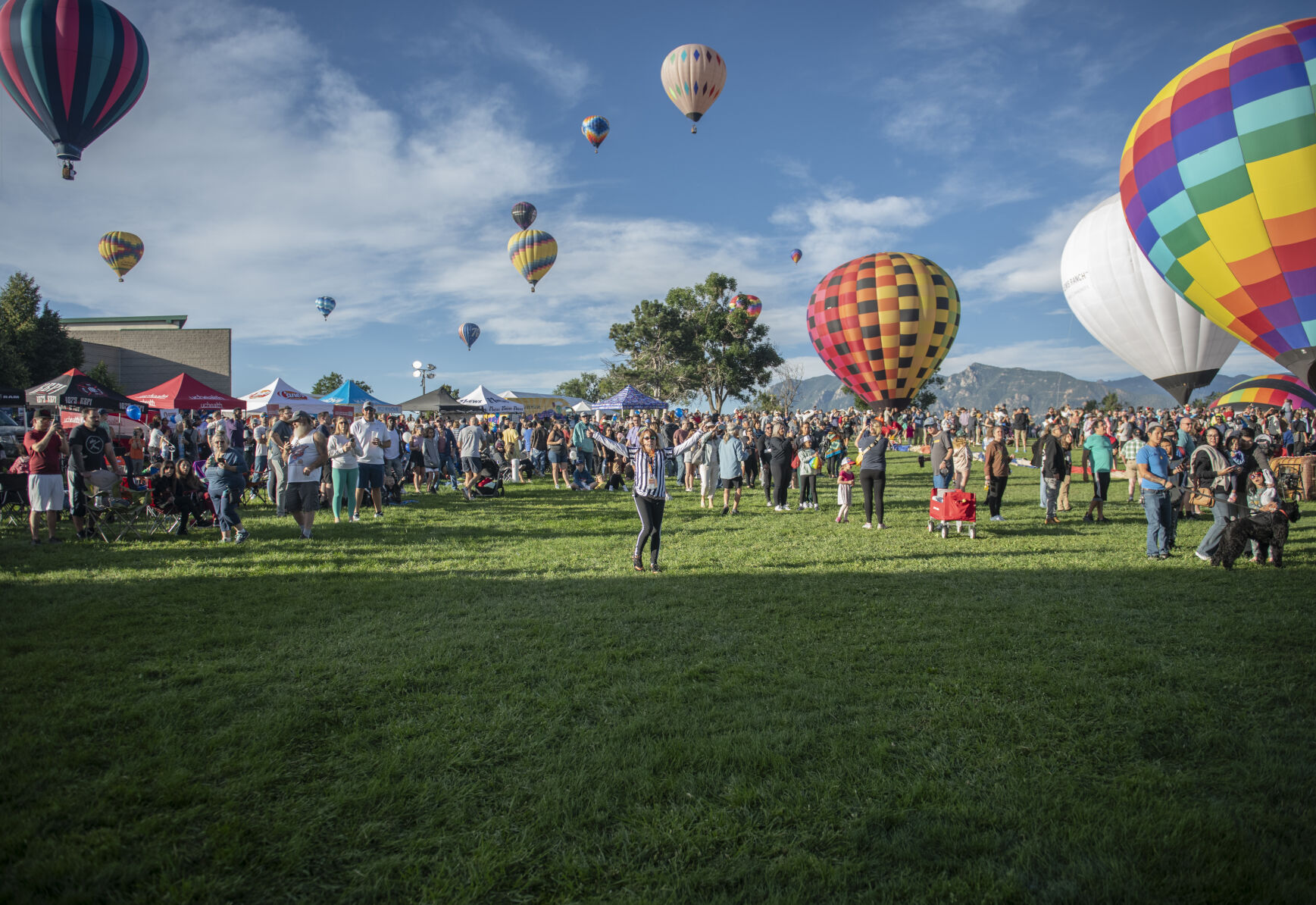 An organizer clears the way for a balloon take off from Memorial Park for the Labor Day Lift Off in Colorado Springs on Saturday, September 2, 2023. (Gabi Broekema)