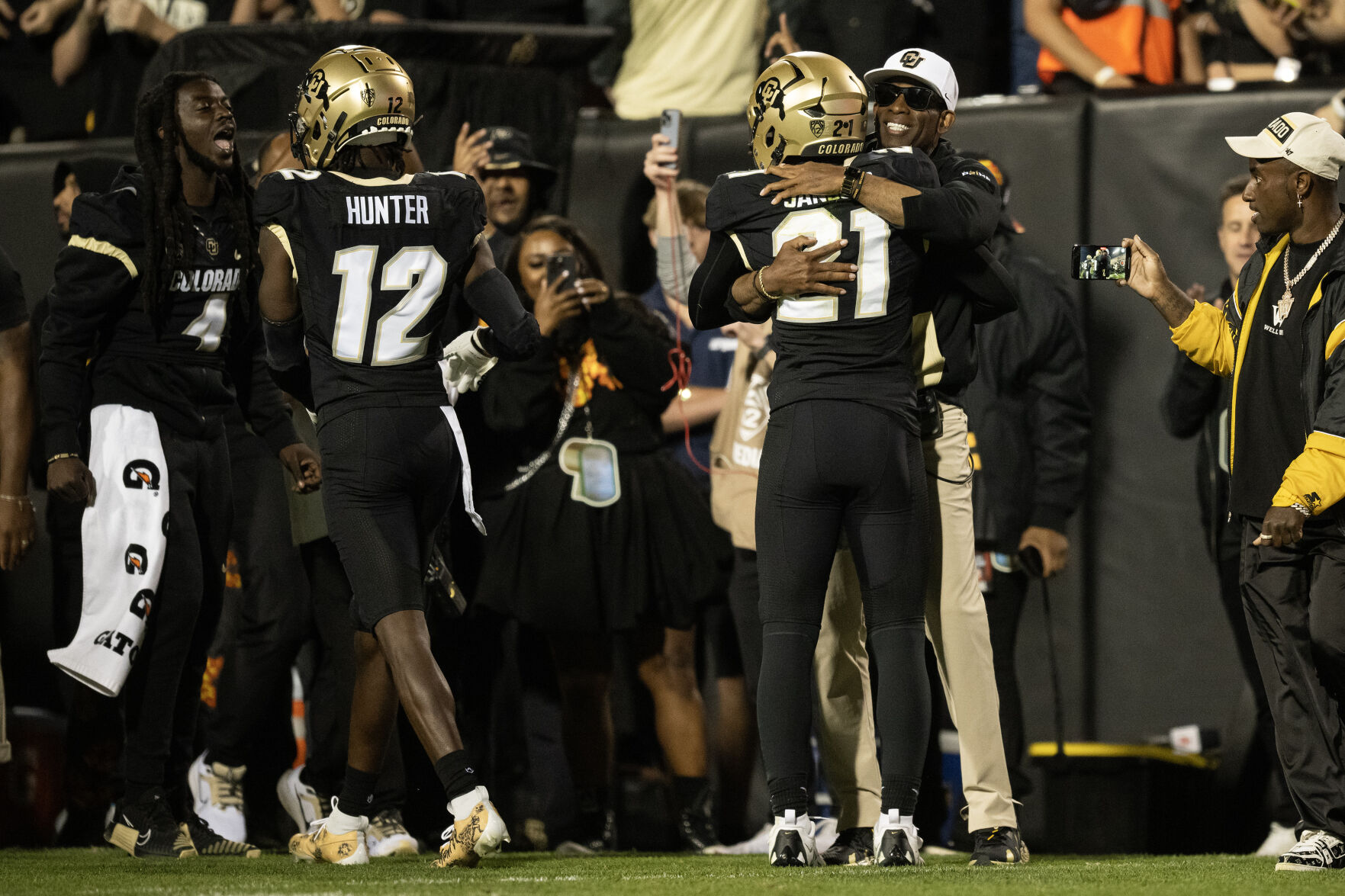 Colorado Buffaloes safety Shilo Sanders (21) hugs his father, Colorado Buffaloes head coach Deion Sanders, after running back in interception during the first quarter of the Rocky Mountain Showdown at Folsom Field on Saturday, Sept. 16, 2023, in Boulder, Colo. (Timothy Hurst/Denver Gazette) (TimHursttim.hurst@gazette.comhttps://secure.gravatar.com/avatar/aca82bd62b4ee425c598527cd6faa1b1?d=mm&r=g)